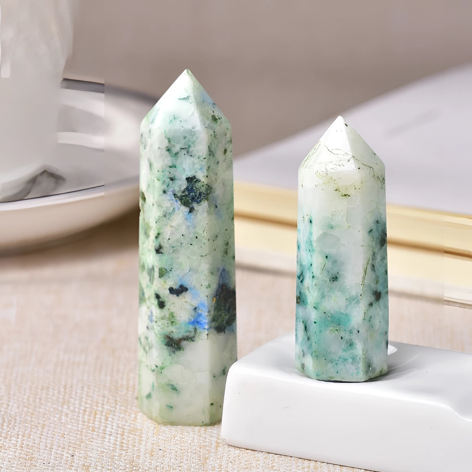 A tall, polished purple and blue fluorite crystal tower with a smooth, glossy surface, resembling a finely crafted obelisk, designed for healing and gifting purposes.
