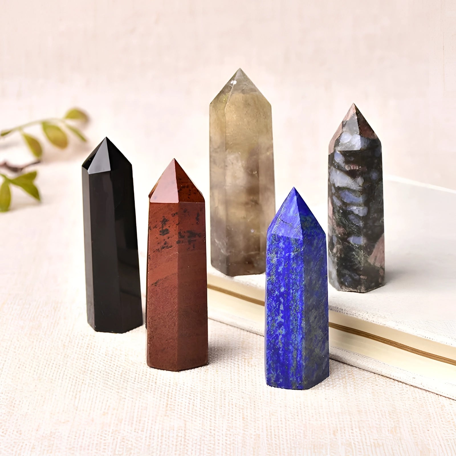 Purple and blue fluorite crystal tower with a polished obelisk shape designed for healing and decorative purposes.