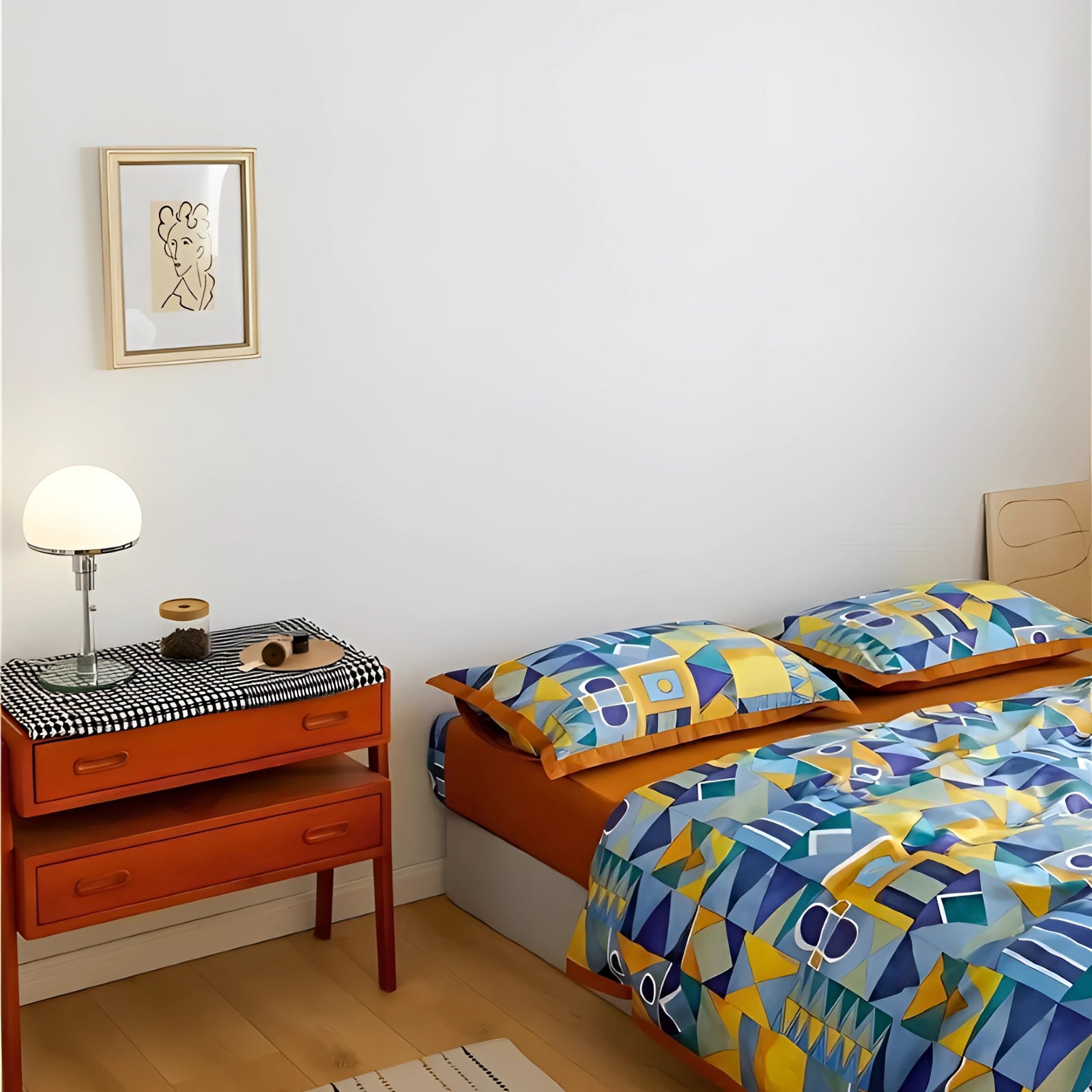 Geometric pattern Egyptian cotton duvet cover on a modern bed with a wooden frame, placed on a hardwood floor, accompanied by a lamp and picture frames as part of the decor.