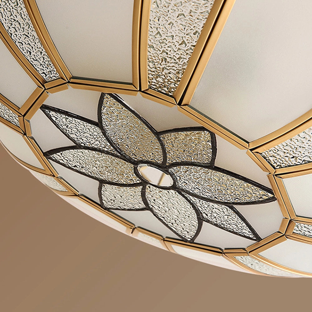 Gold Art Deco semi-flush ceiling light with frosted glass featuring a symmetrical pattern, metal elements, and geometric shapes.