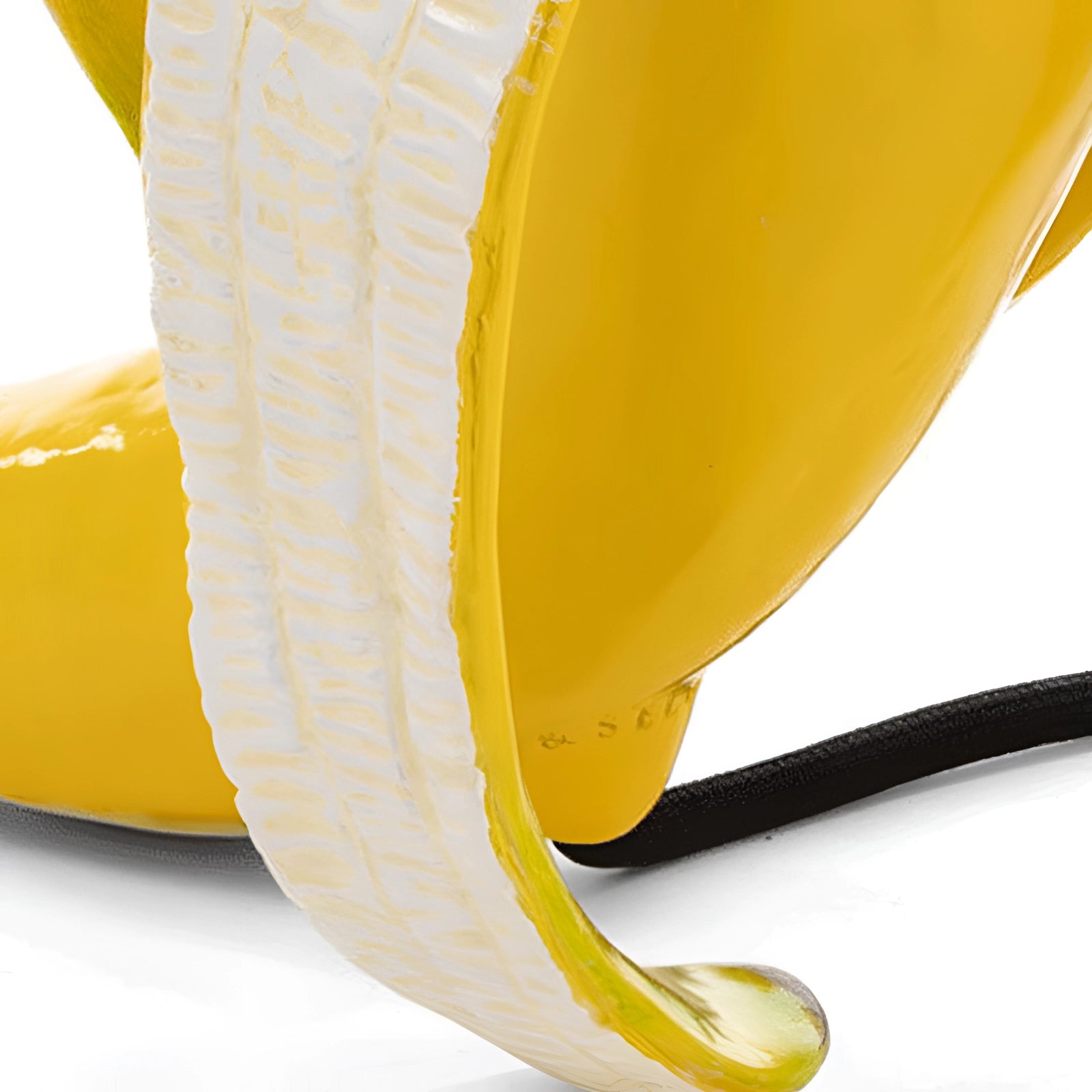 
A modern art sculpture table lamp featuring a gold banana design, crafted from resin, displayed on a wooden table.