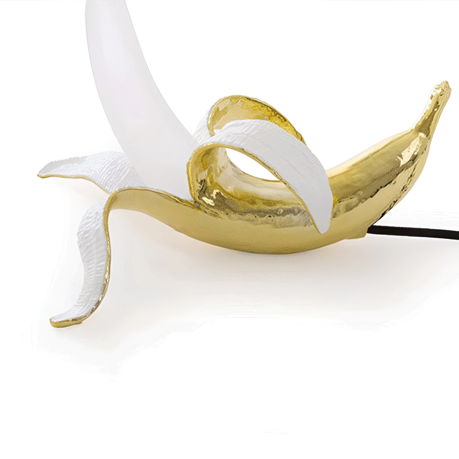 
A modern art table lamp shaped like a gold banana, crafted from resin and designed as a sculpture. The lamp is in a lying position, creating a unique and artistic decor piece that resembles fruit.
