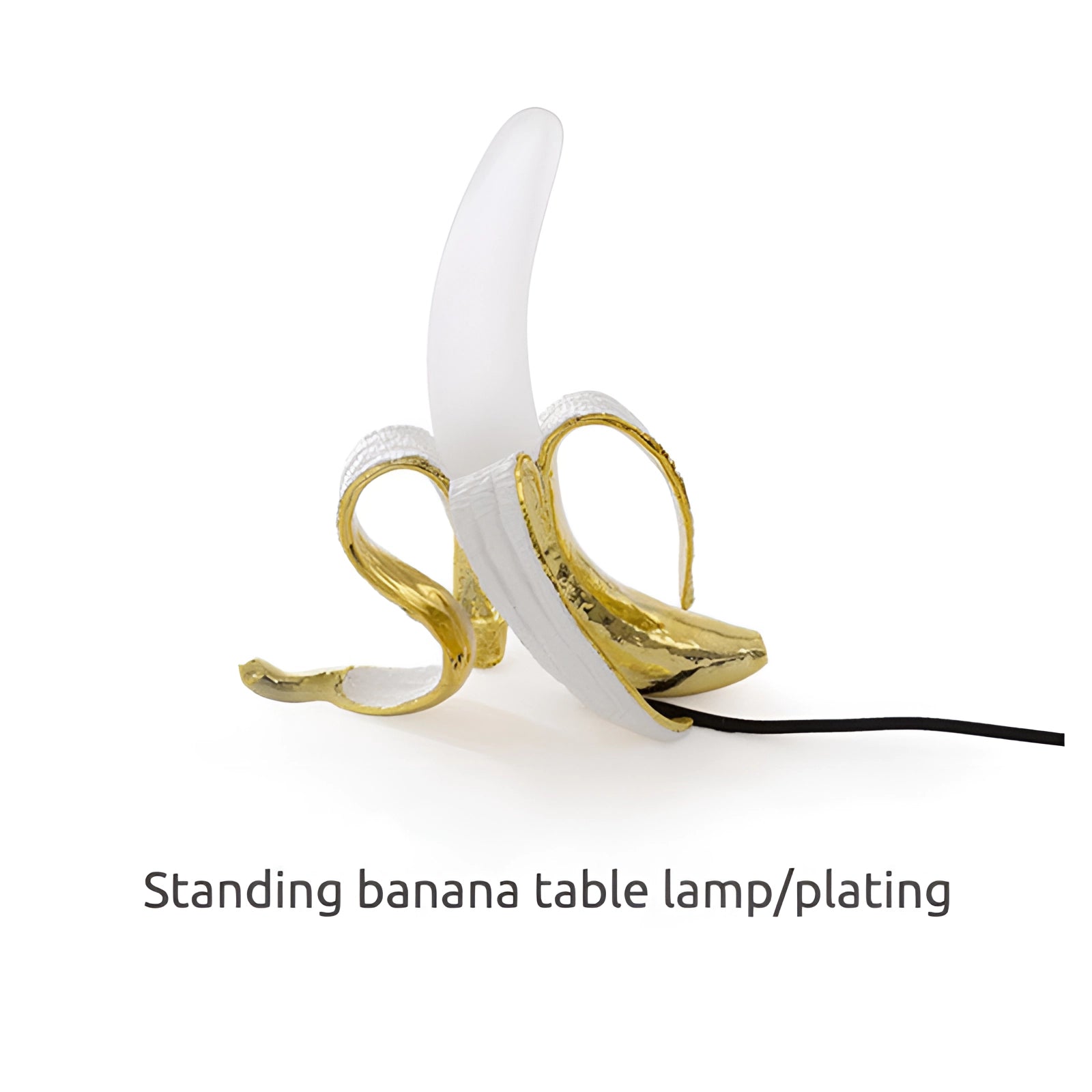 Gold banana-shaped resin table lamp designed as a modern art fruit sculpture decor piece.