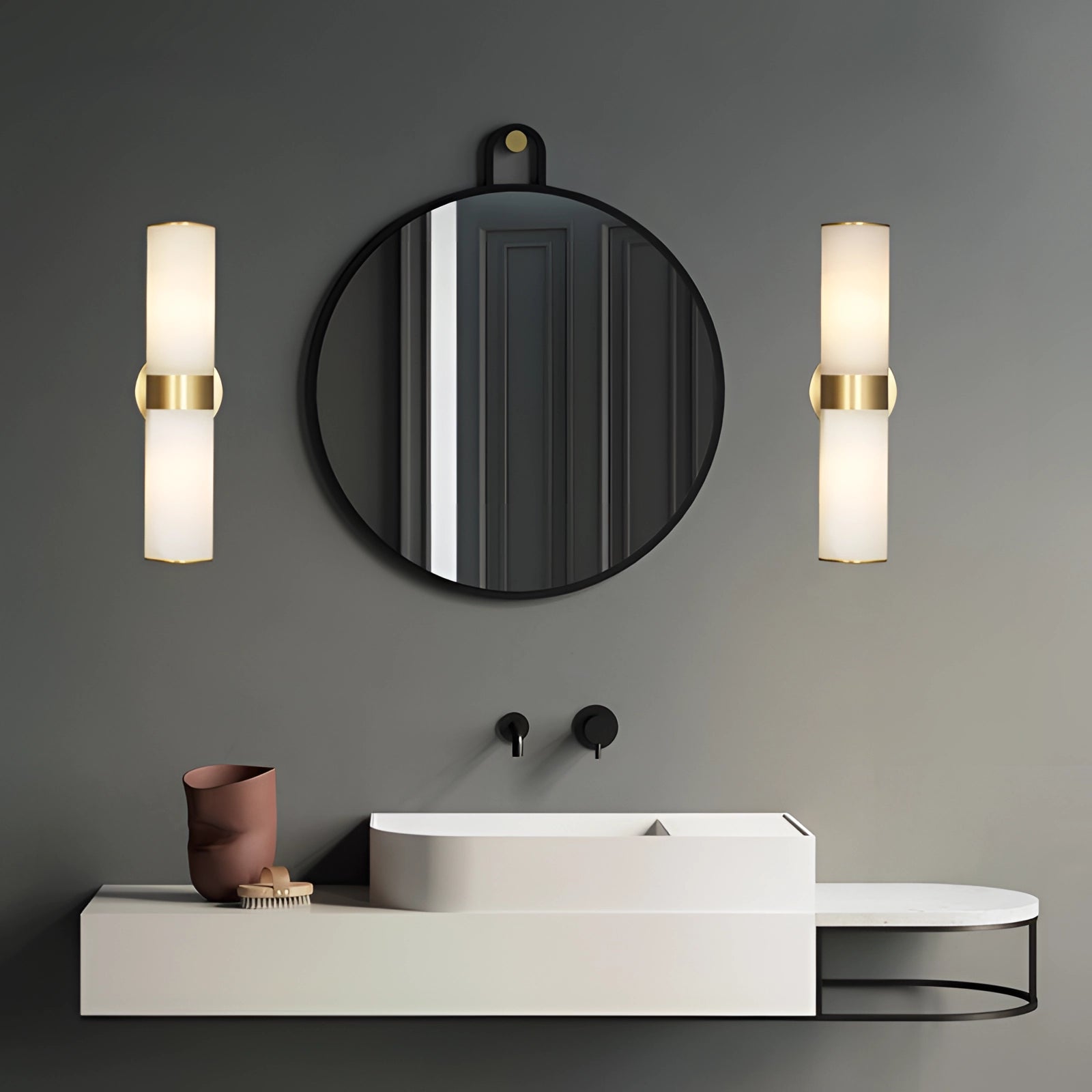 Gold bathroom sconce with cylindrical frosted glass mounted on a wall, providing illumination in a stylish bathroom setting featuring a mirror, tap, rectangular bathroom cabinet, and elegant interior design elements.
