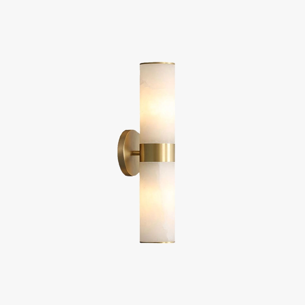 Gold bathroom sconce featuring a cylindrical frosted glass wall light fixture, set against a wooden surface.
