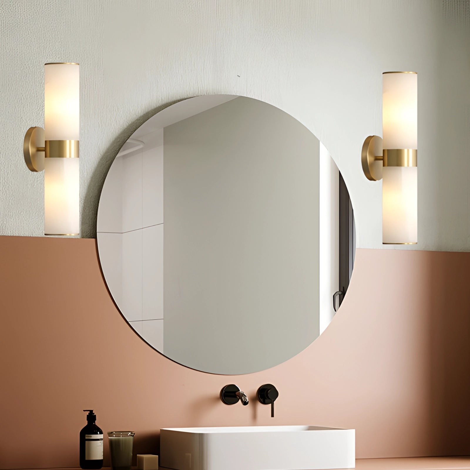 Gold bathroom sconce with cylindrical frosted glass wall light, featuring a sleek design suitable for modern interior spaces.