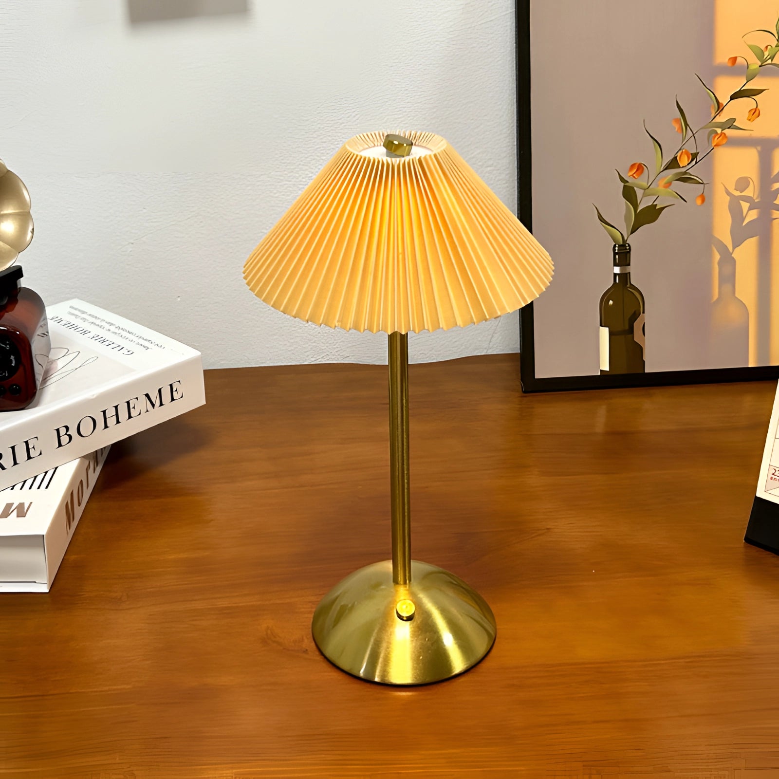 Vintage mid-century gold brass floor lamp with pleated shade next to a wooden table with a houseplant and flowerpot.