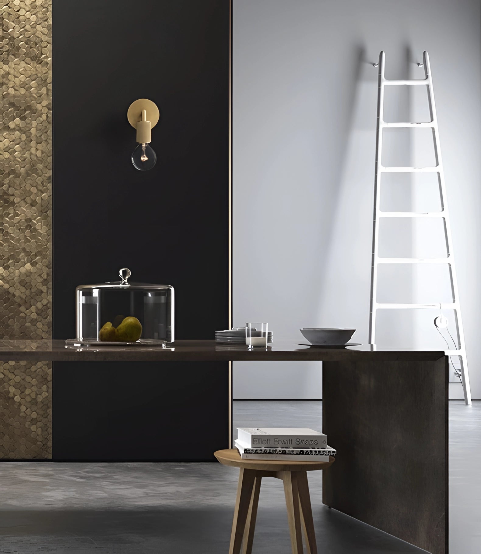 Gold brass wall sconce with a geometric glass design, featuring a vintage bulb in an industrial minimal style mounted on a wall.