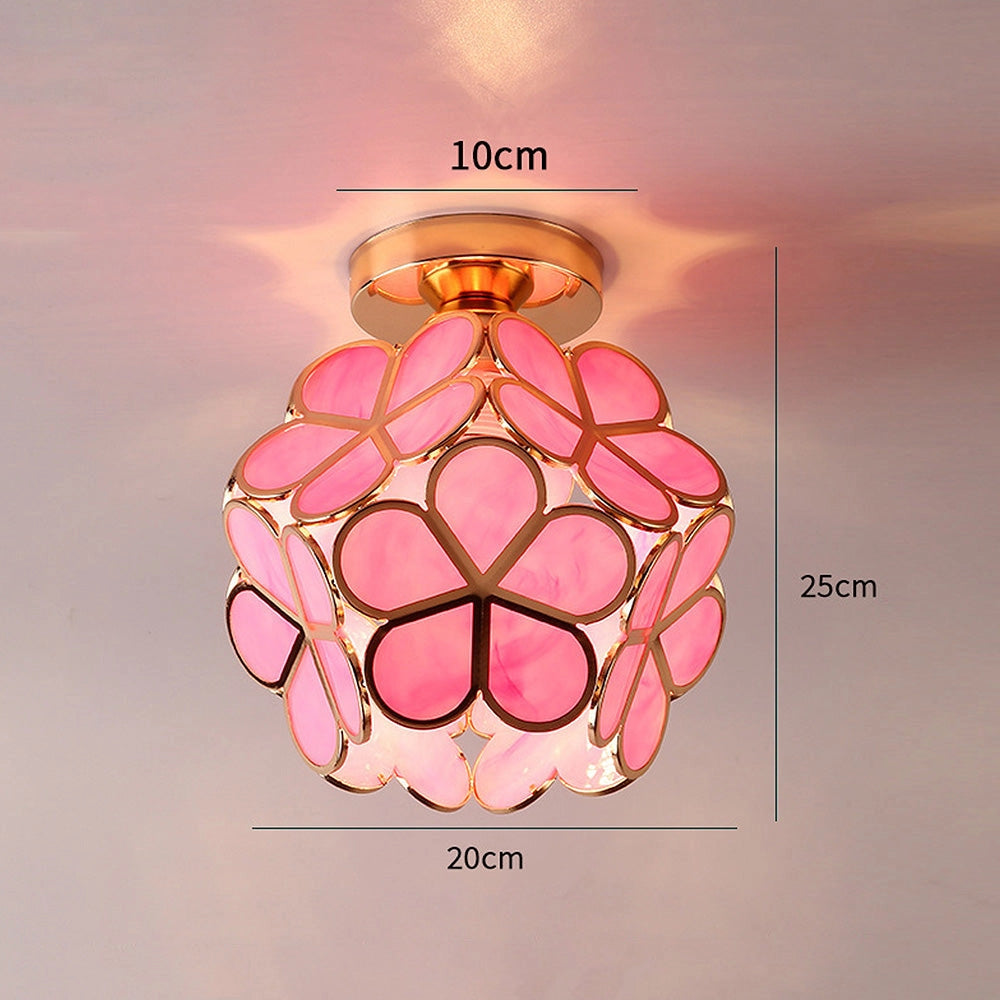 Gold flush mount artistic glass ceiling light with a modern geometric design featuring circular patterns and symmetrical detailing.