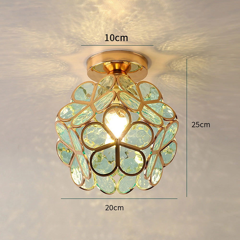 Gold flush mount ceiling light with an artistic glass design featuring a modern geometric pattern, resembling a chandelier with circular symmetry. The light fixture is mounted on the ceiling, providing an elegant and stylish illumination.