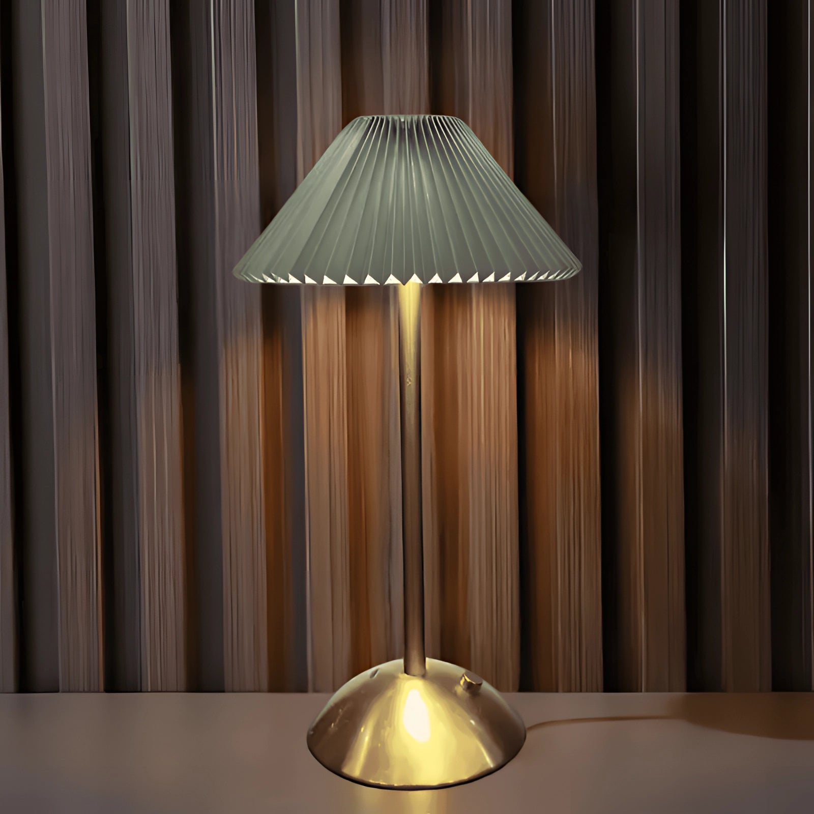 Gold mid-century brass floor lamp with a pleated green lampshade, showcasing elegant lighting and modern design elements.