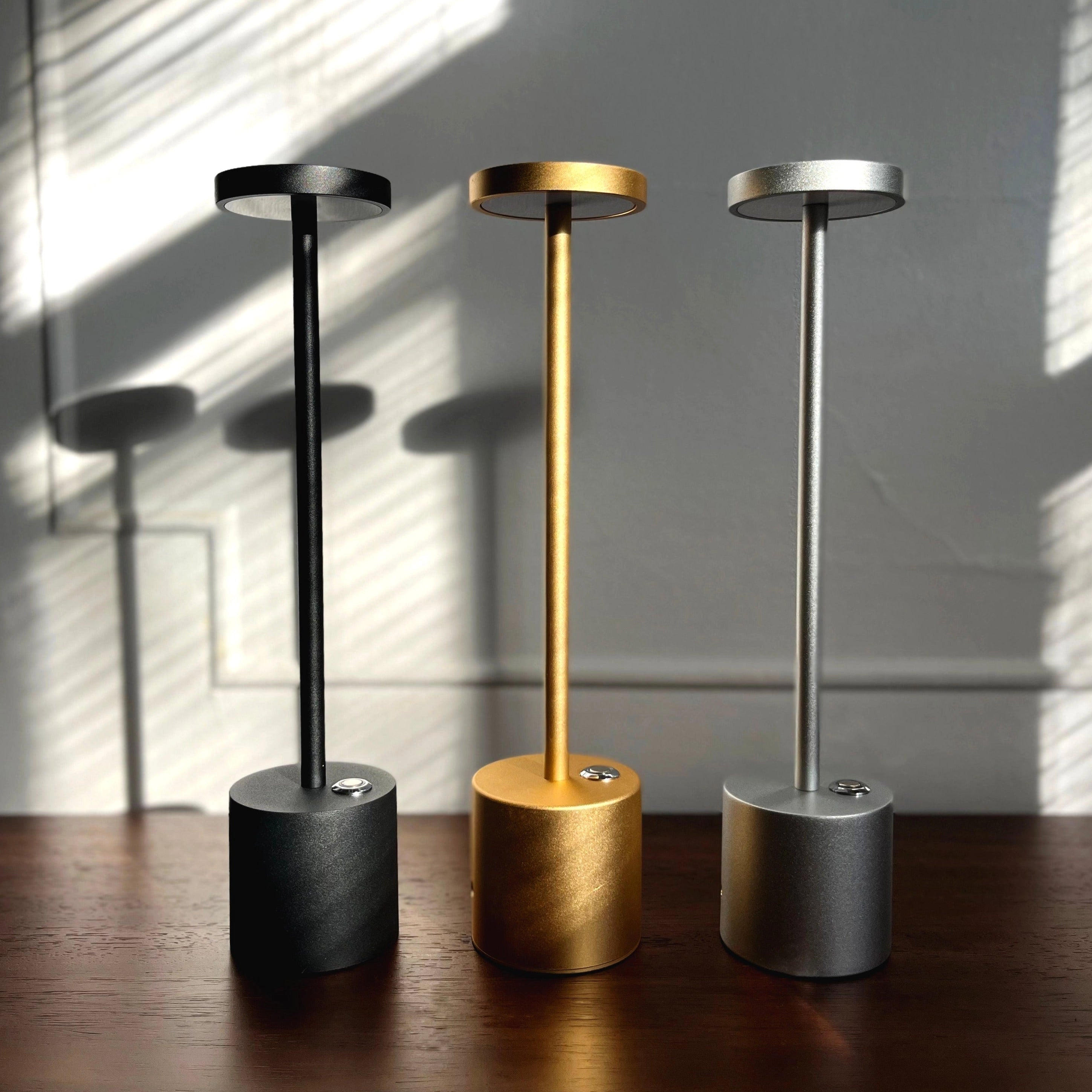Gold Minimalistic LED Desk Lamp with Circular Head and Brass Finish, placed on a wooden surface.
