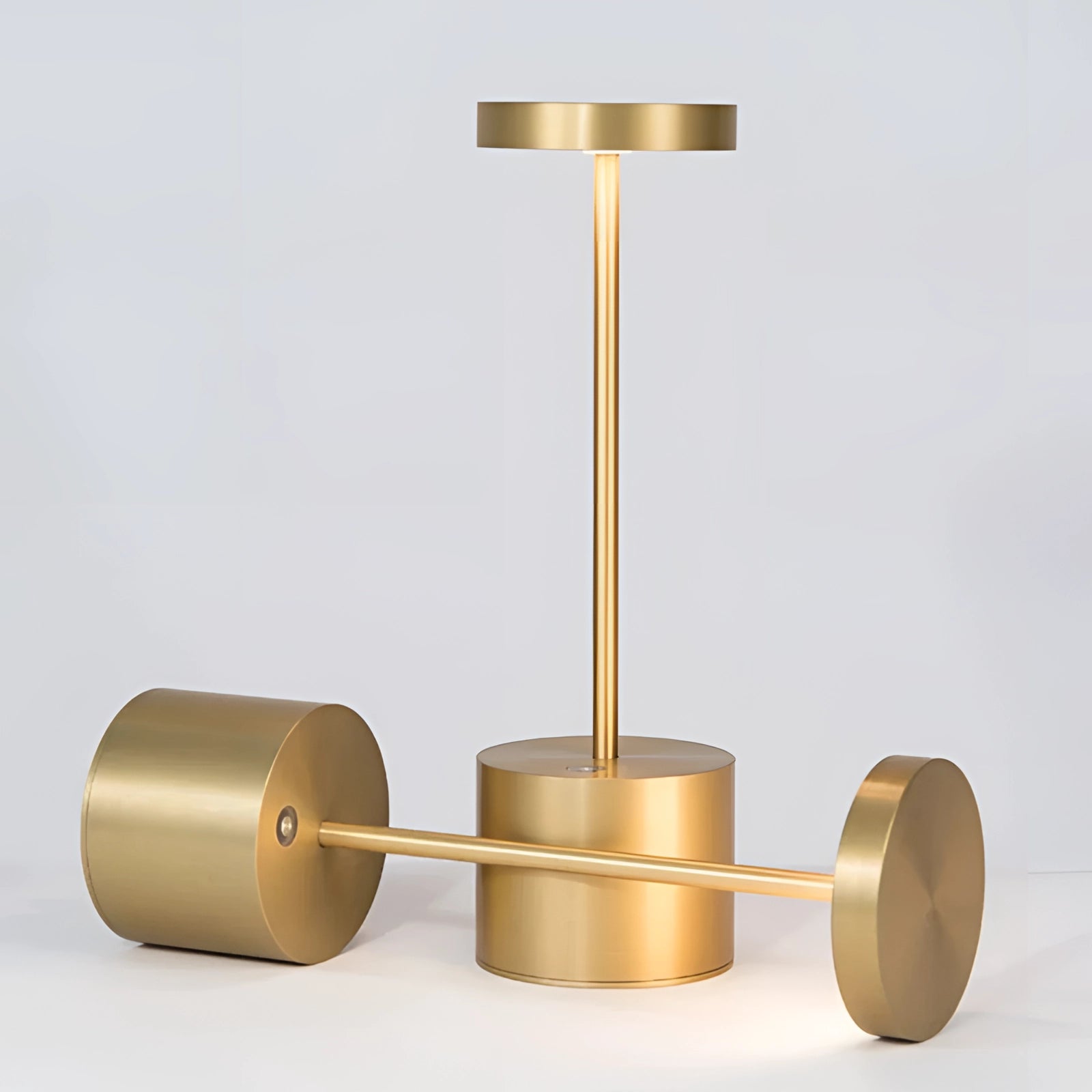 Gold Minimalistic LED Desk Lamp with Circular Head in Brass Finish on Wooden Desk
