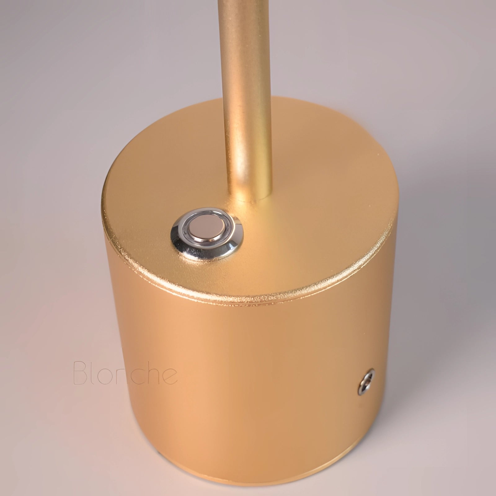 Gold Minimalistic LED Desk Lamp with Circular Head and Brass Finish on a sleek modern desk.