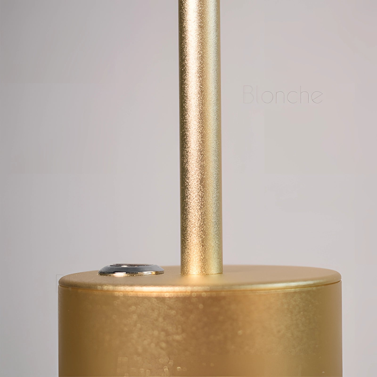 Gold Minimalistic LED Desk Lamp with Circular Head and Brass Finish, placed on a wooden desk.