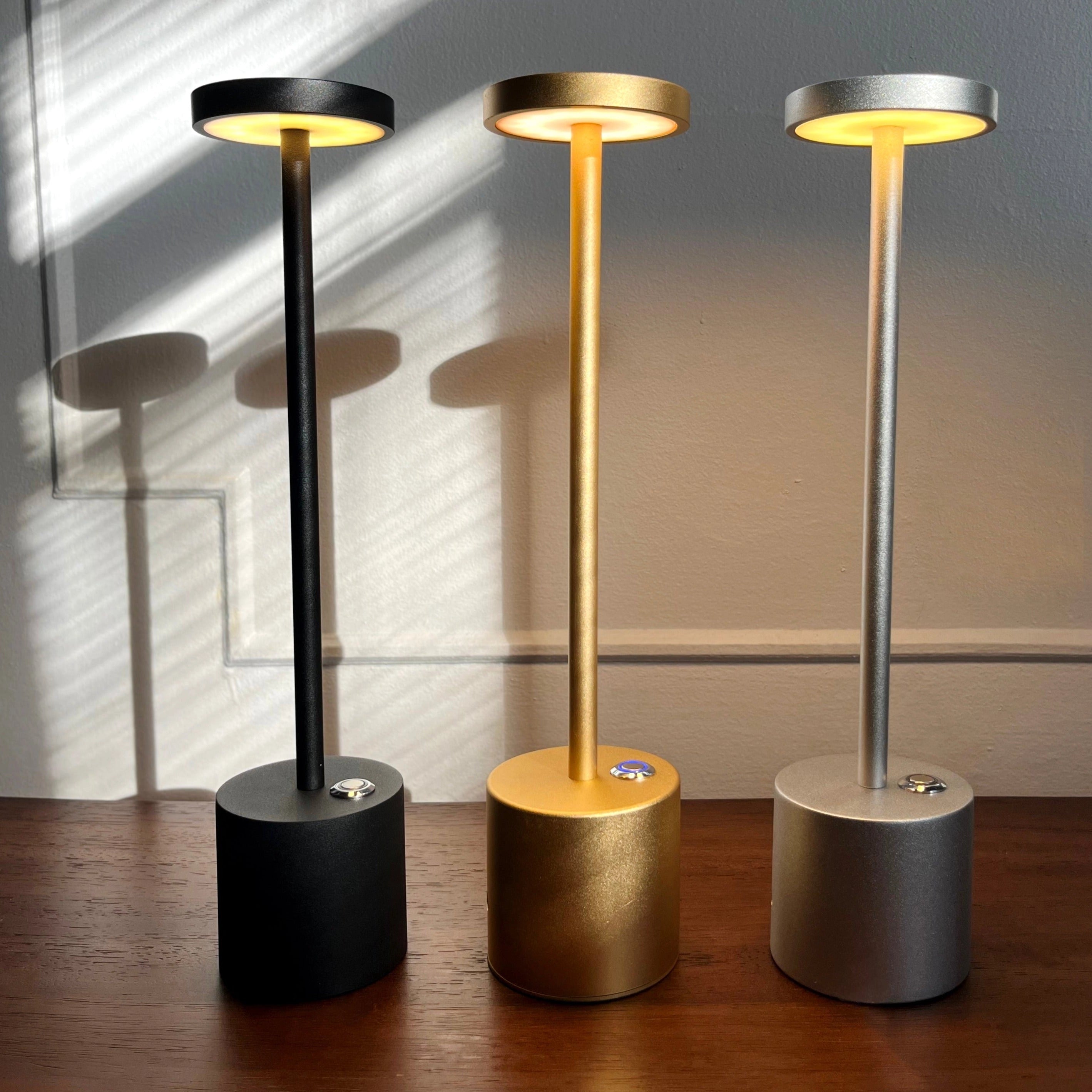 Gold Minimalistic LED Desk Lamp with Circular Head and Brass Finish, placed on a wooden surface.