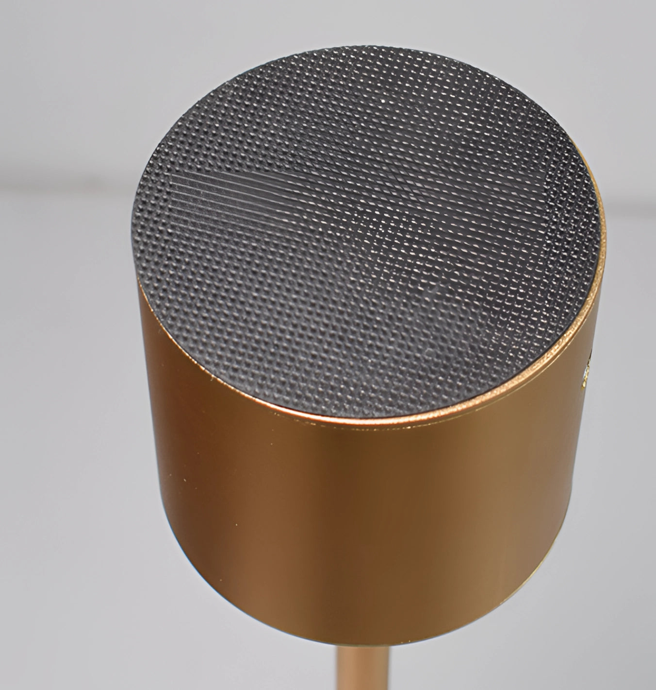 Gold Minimalistic LED Desk Lamp with Circular Head and Brass Finish on a Stylish Wooden Table.
