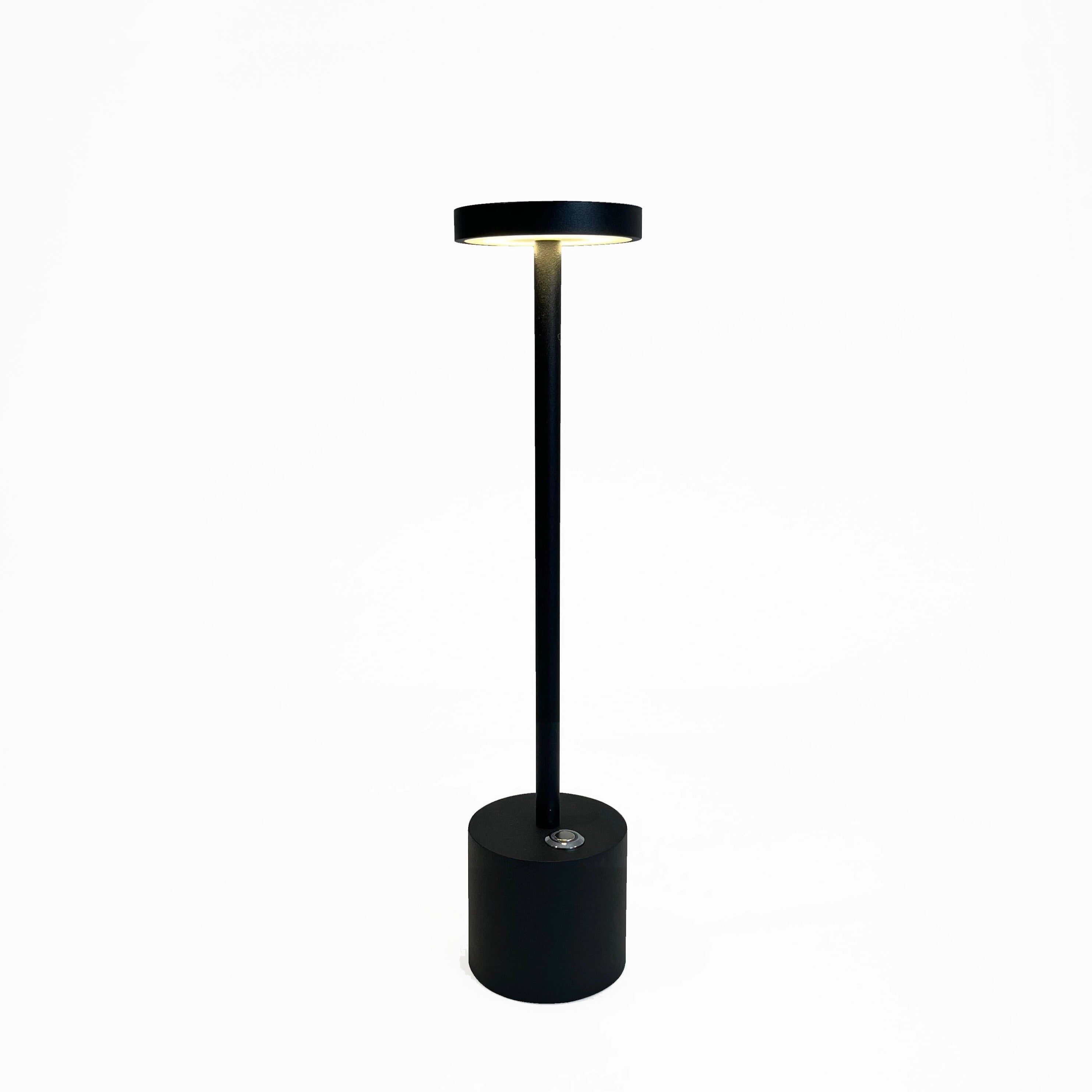 A gold minimalistic LED desk lamp with a circular head and brass finish, displayed in a stylish and balanced setup.