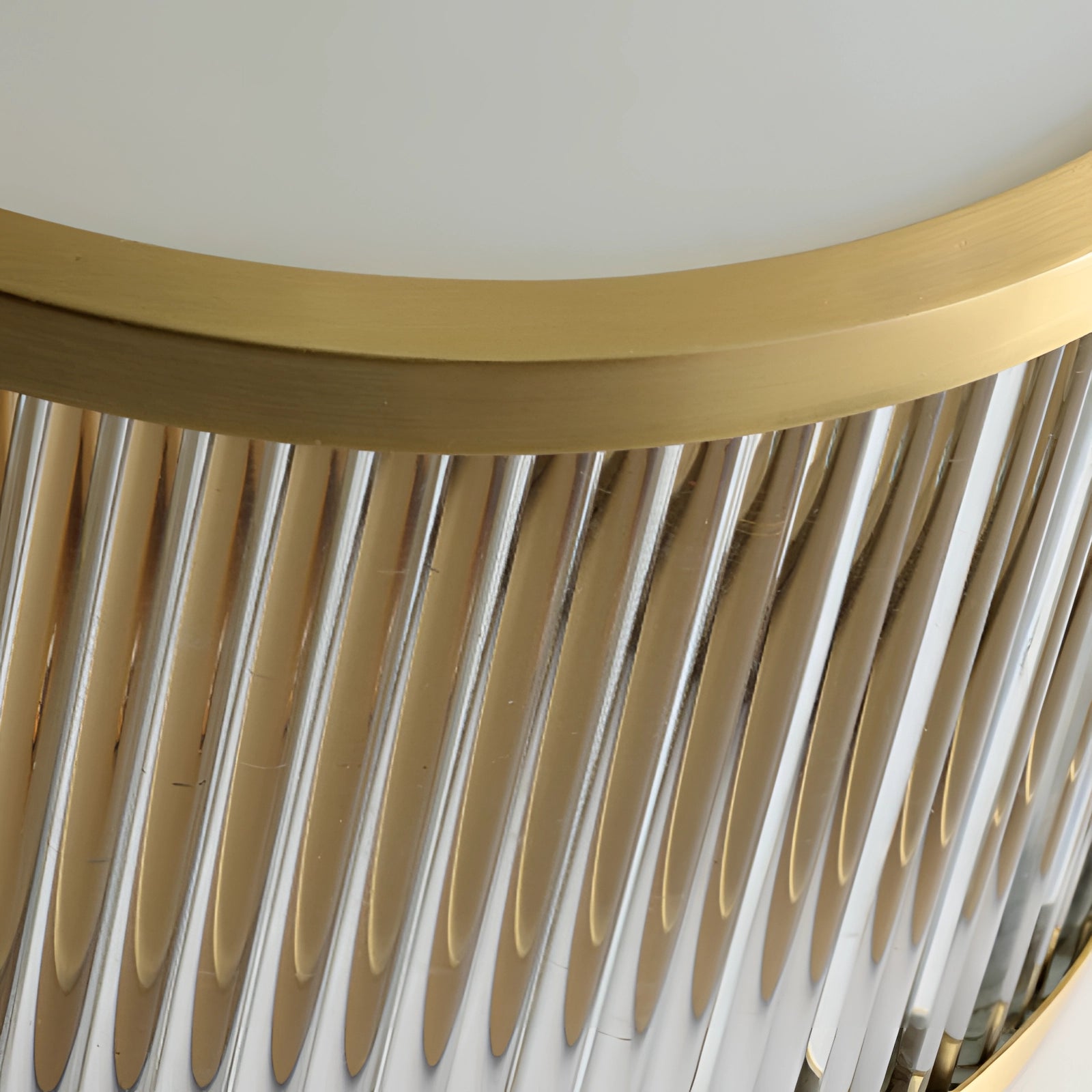 Gold-trimmed circular flush mount ceiling light with elegant decorative design, installed on a wooden ceiling above stairs.