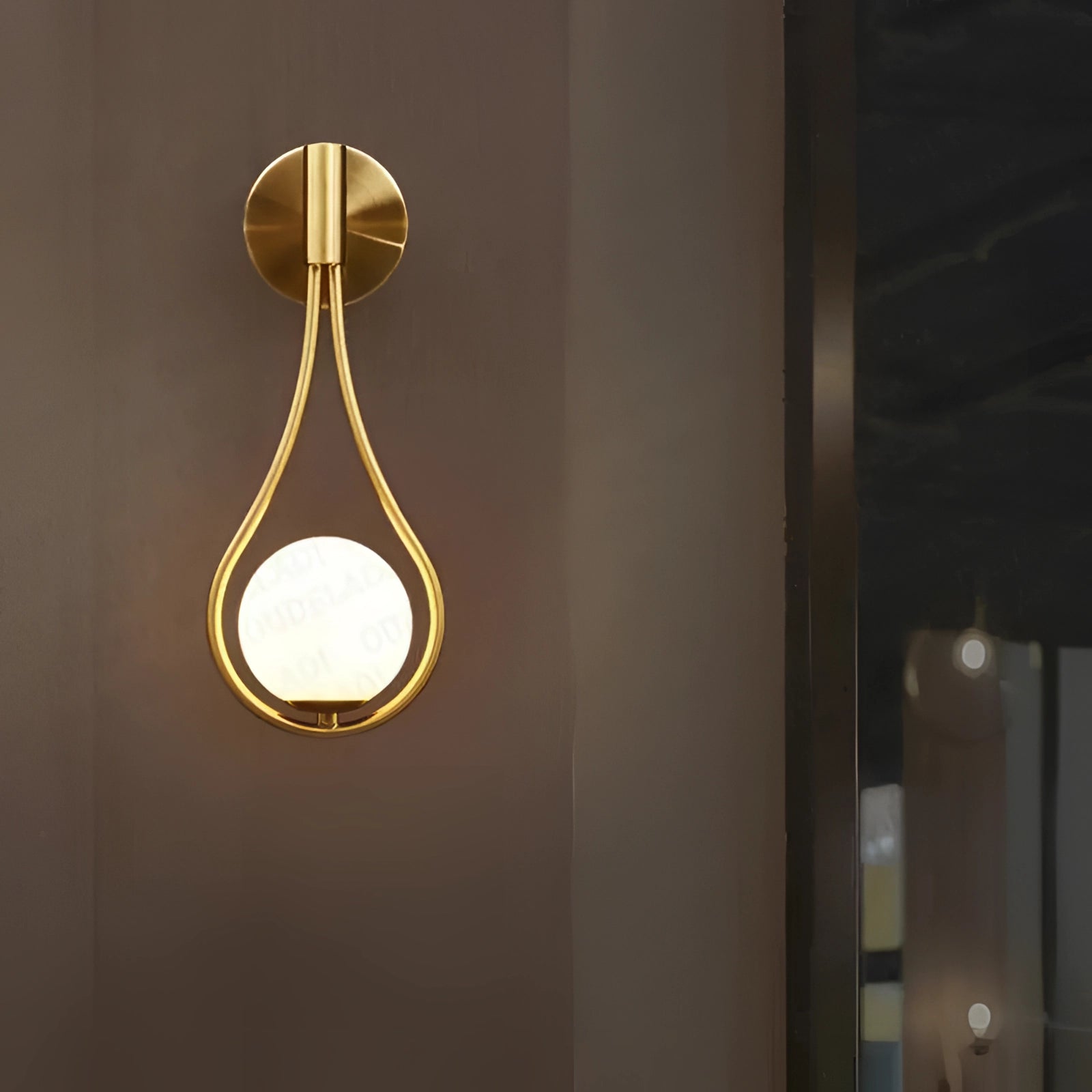 Luxurious gold wall-mounted soap dispenser with a modern design, suitable for upscale bathroom decor, with a reflective metallic finish that complements wooden and other interior elements.