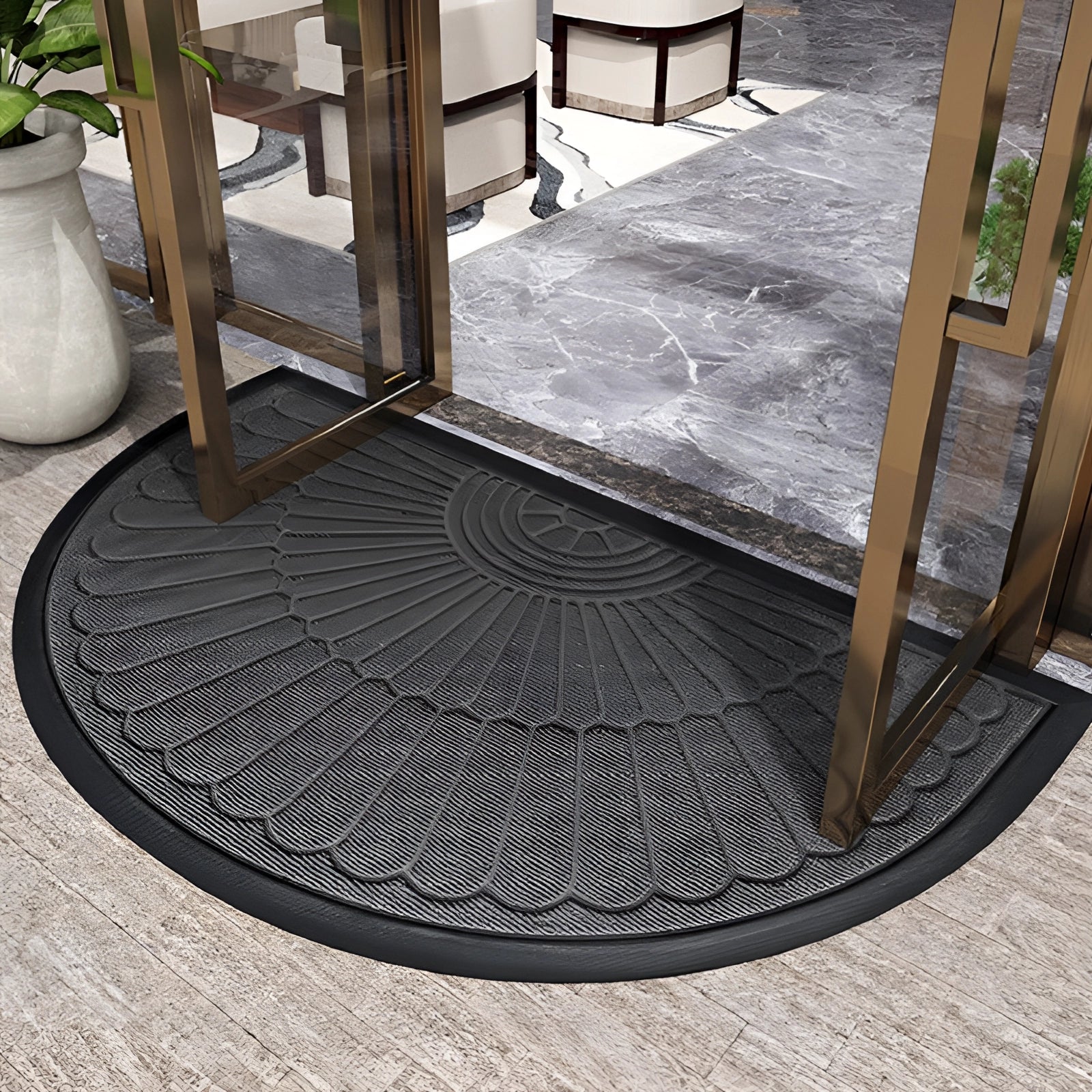 Gray semi-circular non-slip door mat placed on a hardwood floor, featuring an absorbent and durable texture.