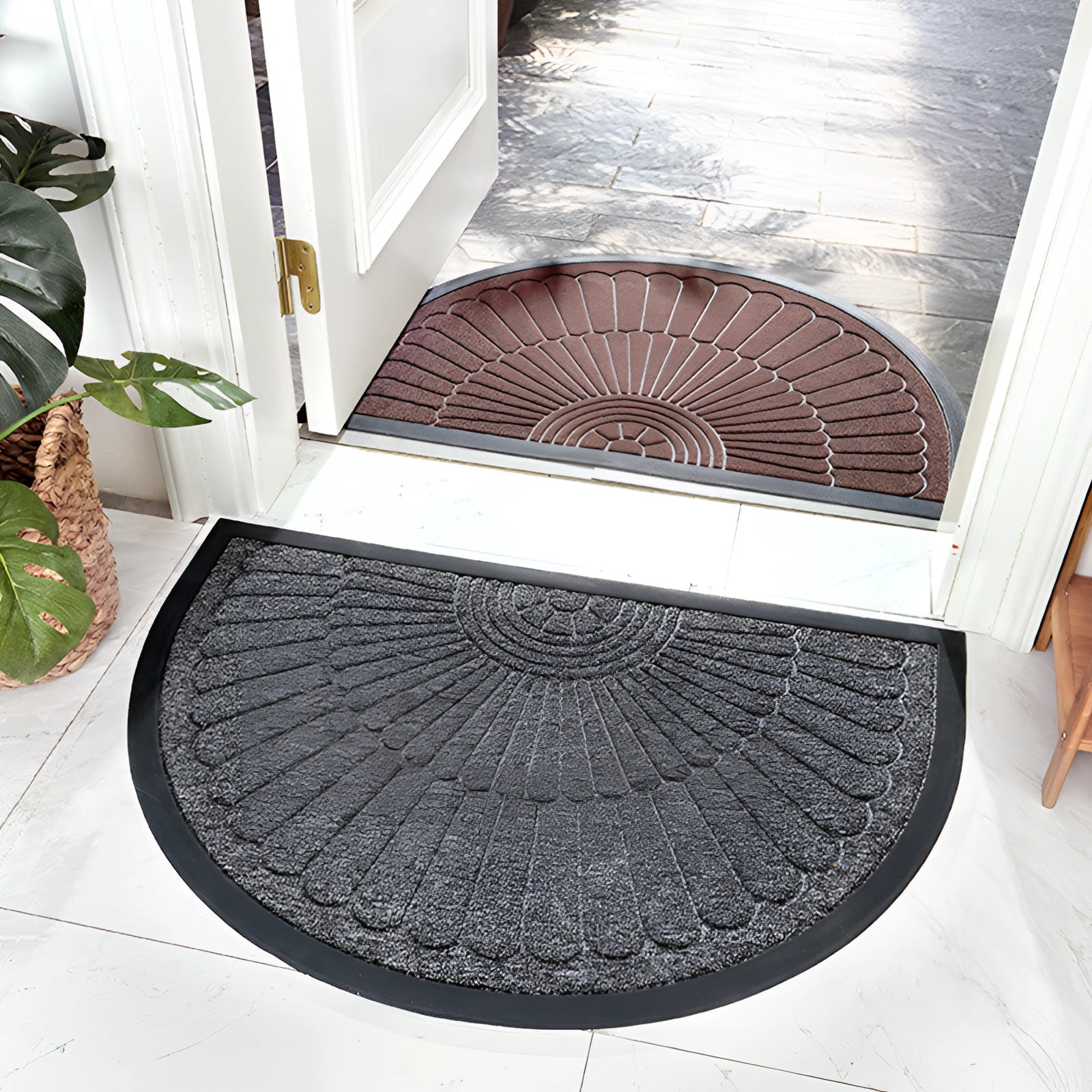 Gray semi-circular non-slip door mat on a hardwood floor, featuring an absorbent and durable design.