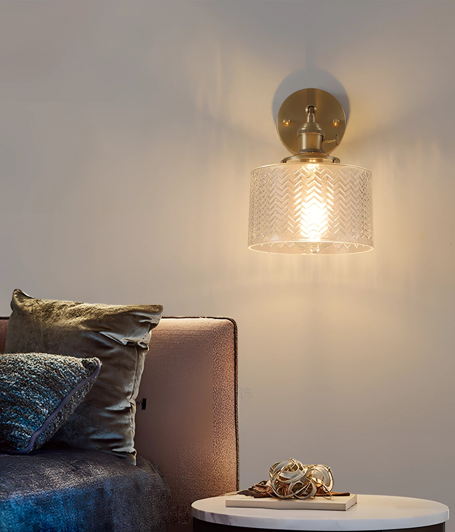 Green chevron wall lamp with a brass sconce and geometric pattern, mounted on a wall in a modern interior setting.