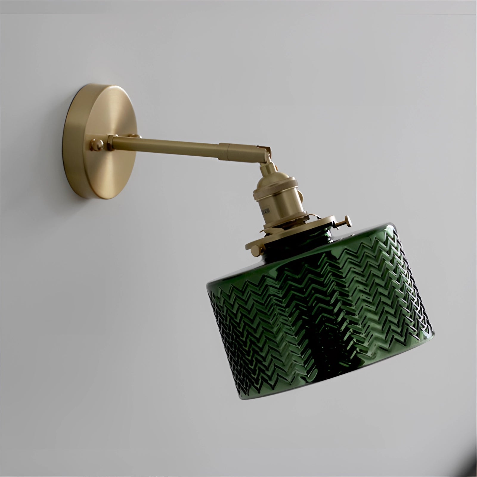 Green Chevron Wall Lamp with a brass sconce featuring a geometric chevron pattern, composed of metal and wood elements, with a rectangular and circular design.