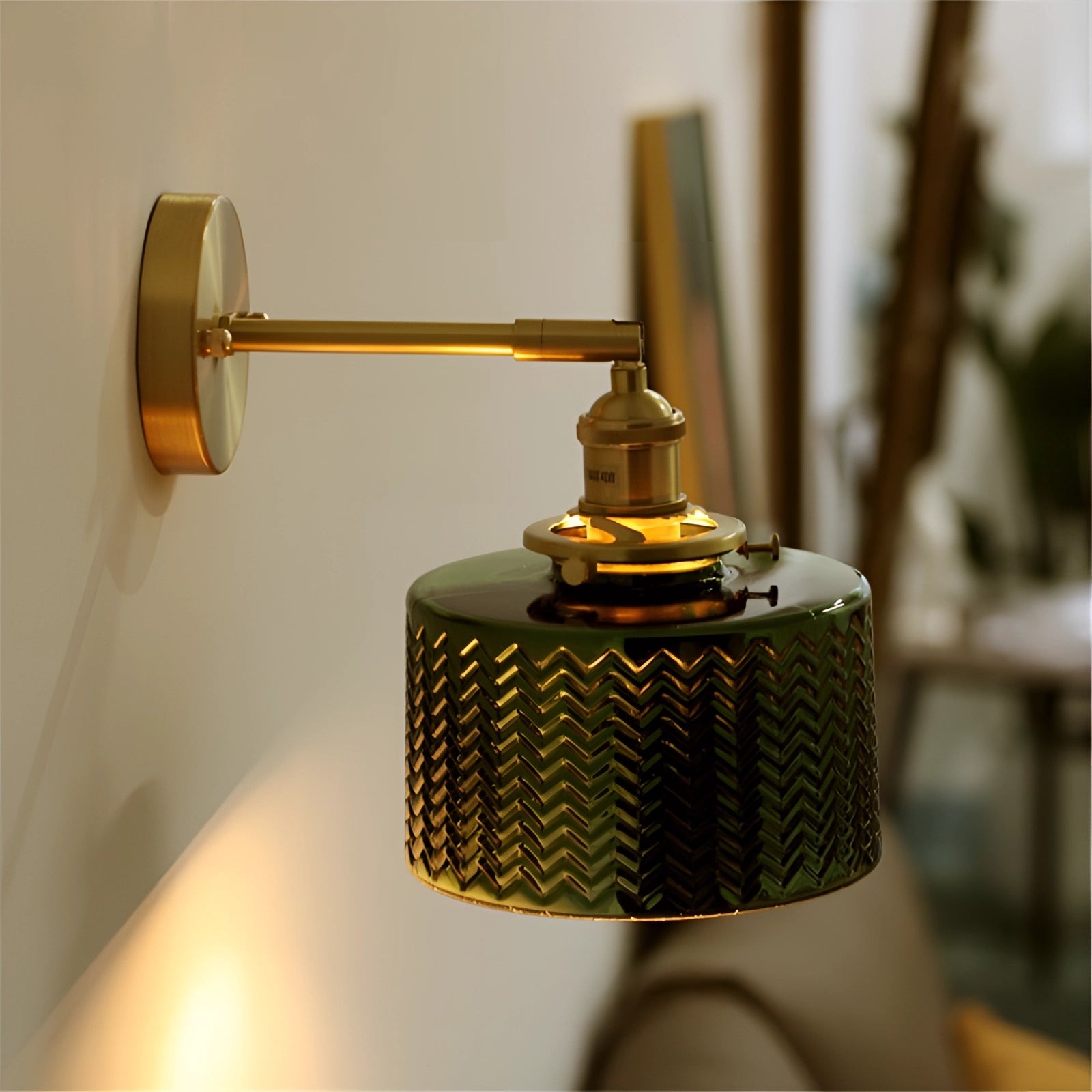 Green Chevron Wall Lamp featuring a brass sconce with a geometric pattern, highlighting its sleek metal design and elegant craftsmanship.