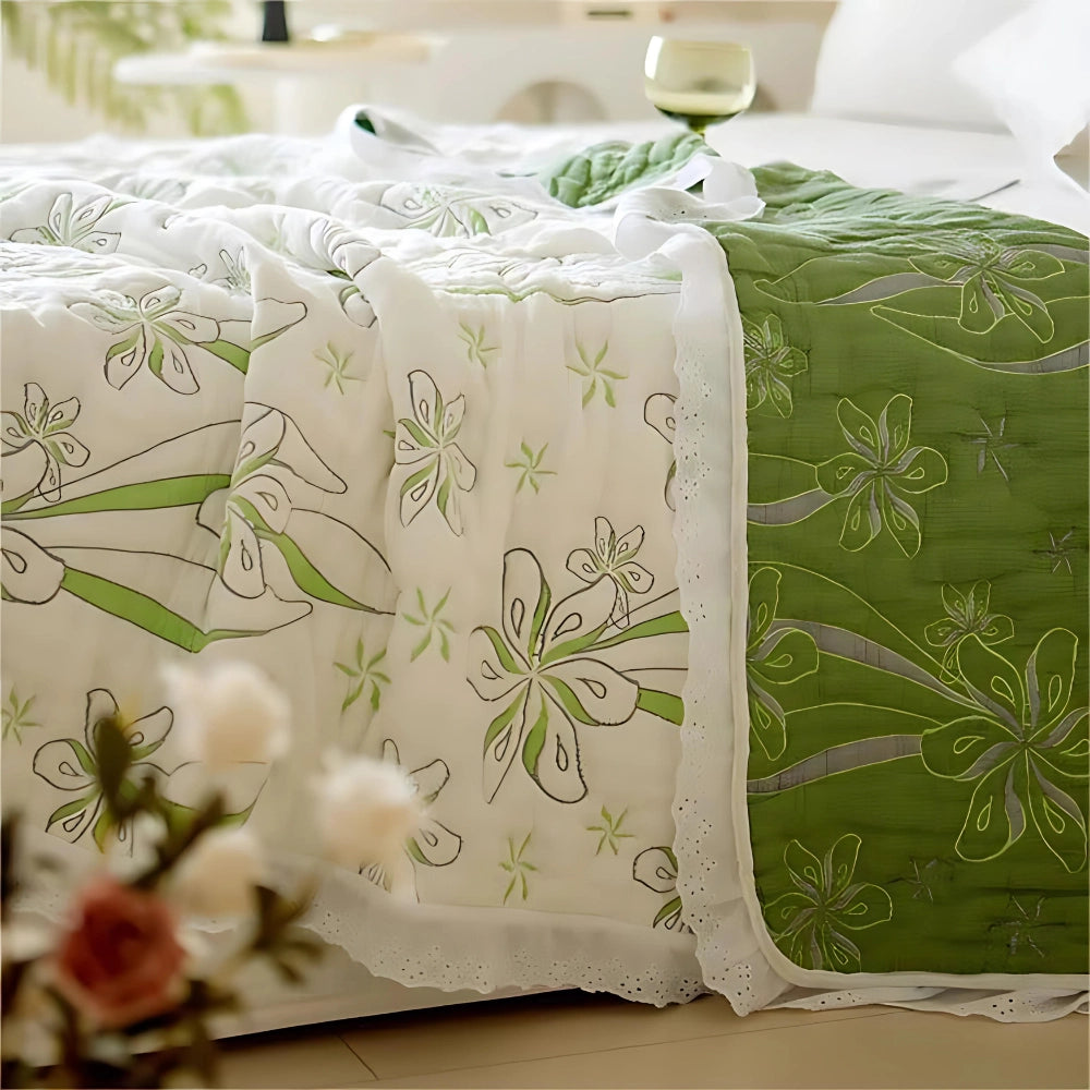 
A luxurious green floral bedding set featuring a designer duvet cover with intricate flower patterns, displayed against a beige background. The set includes creative textile designs that enhance the decor with petal and plant motifs.