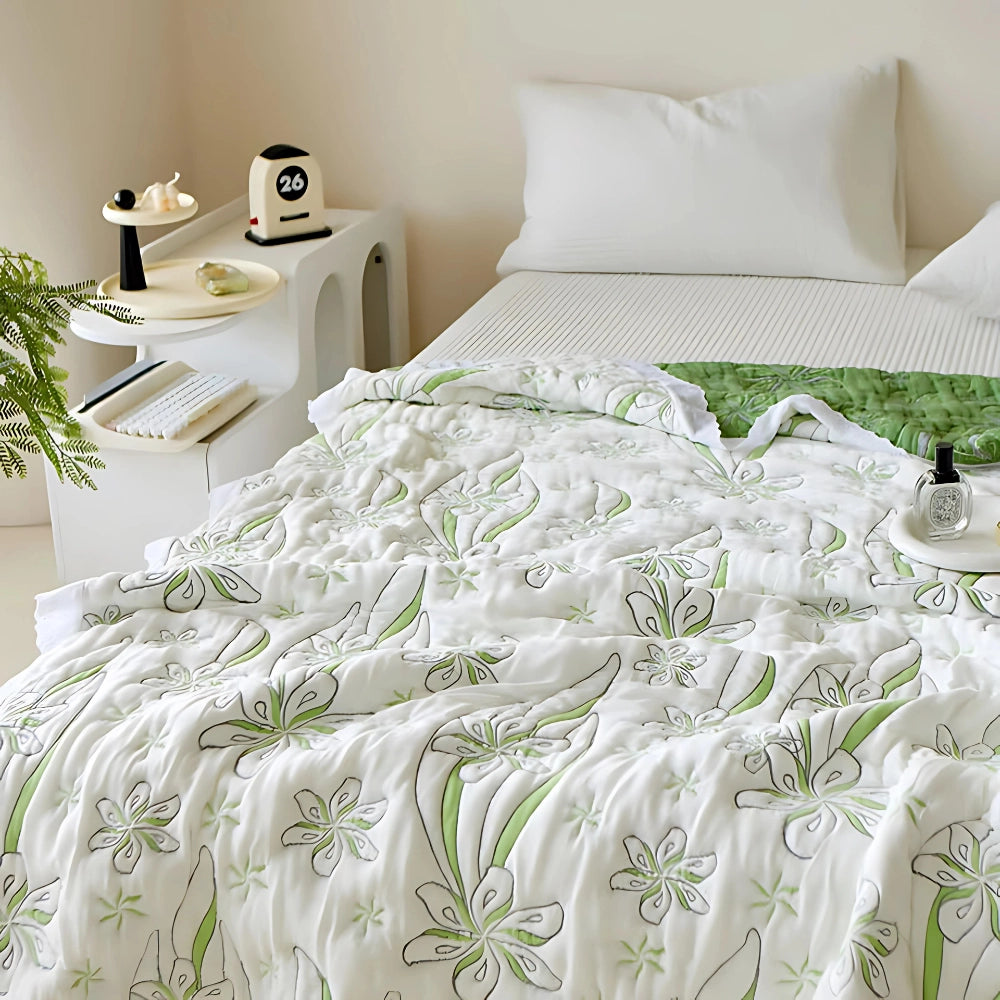 Green floral luxury bedding set with designer duvet cover decor on a white bed, featuring pillows and wooden bed frame, in a stylishly designed interior setting.