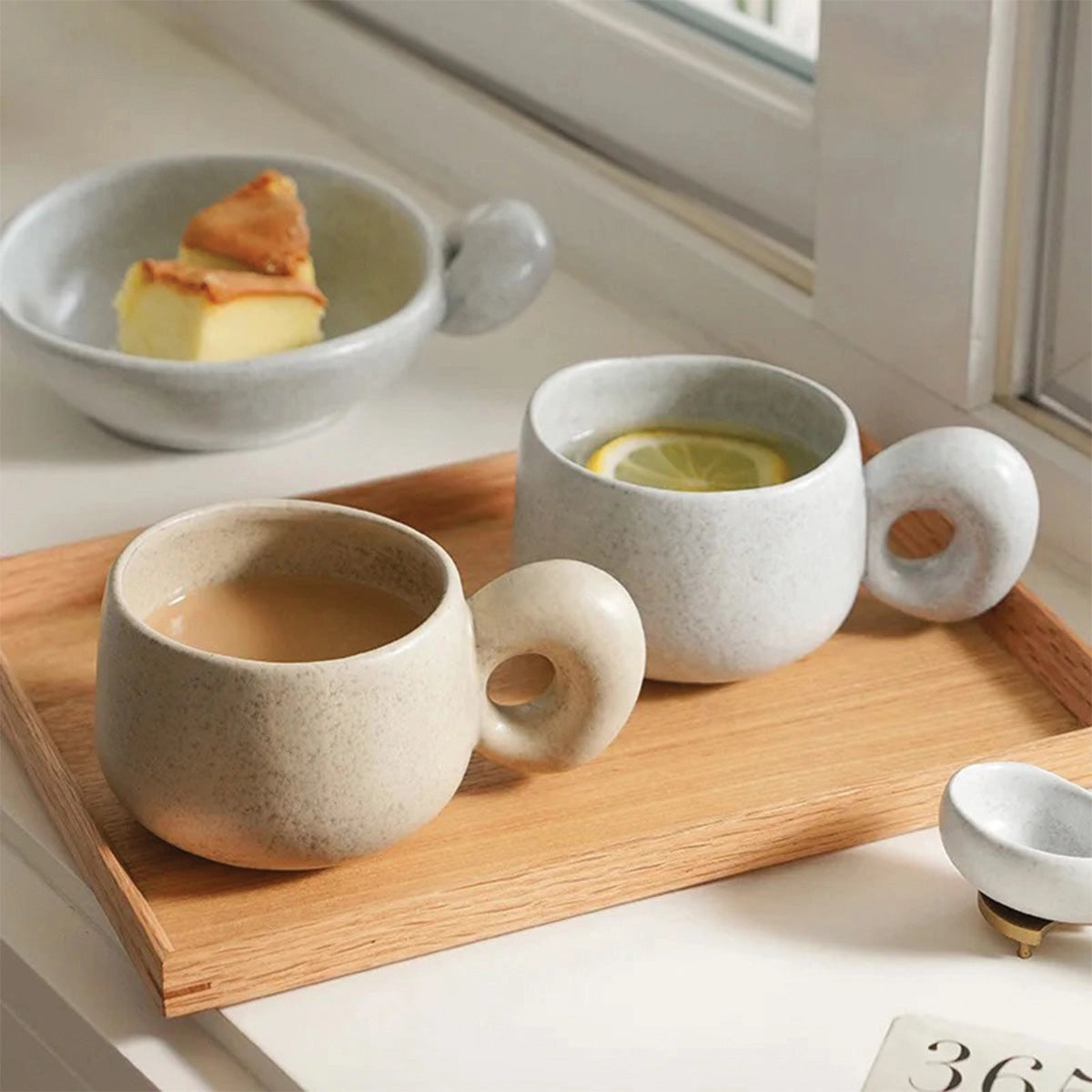 Handcrafted speckled ceramic mug on a wooden table, featuring a smooth texture and earthy tones, designed for eco-friendly coffee enjoyment.