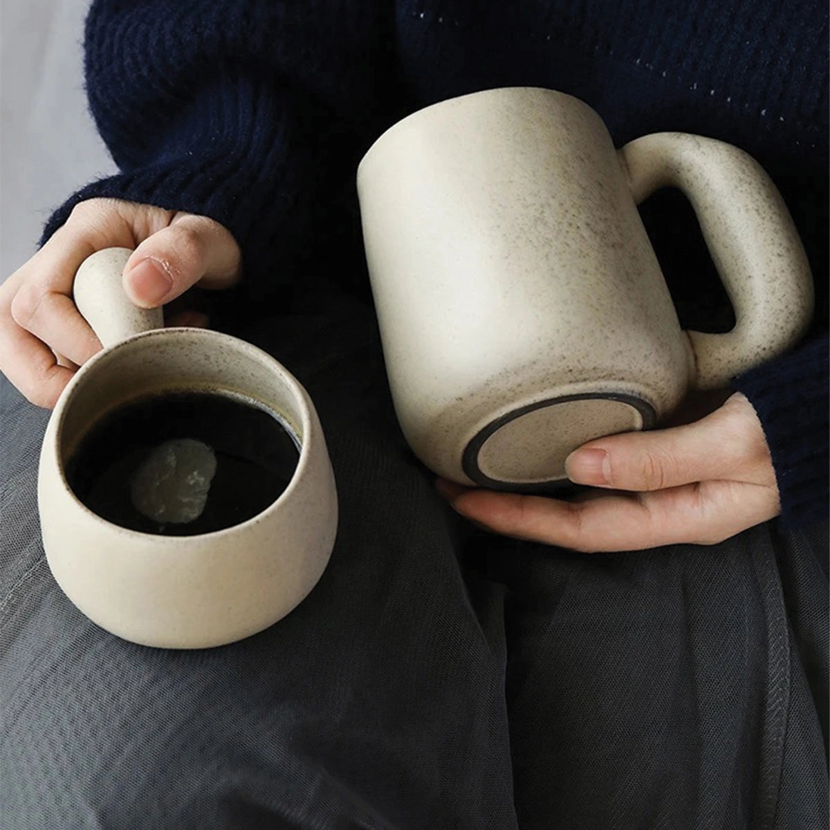 Handcrafted speckled ceramic mug with a smooth, rounded shape. The eco-friendly artisan coffee cup features a natural speckled pattern and an ergonomic handle, perfect for a comfortable grip.