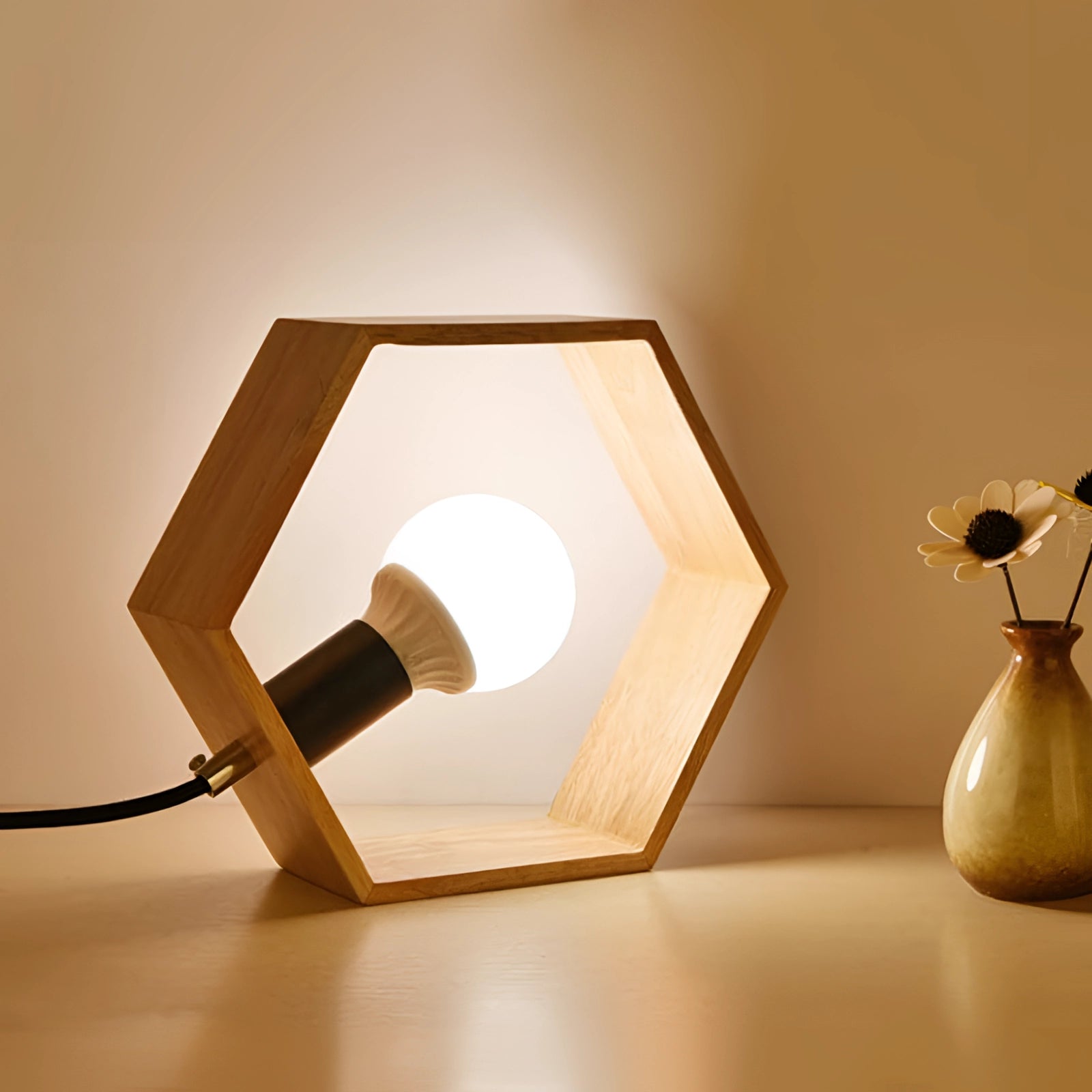 Hexagonal wooden lamp with minimalist geometric design, featuring a warm light emanating from its wooden structure, ideal as a desk light.