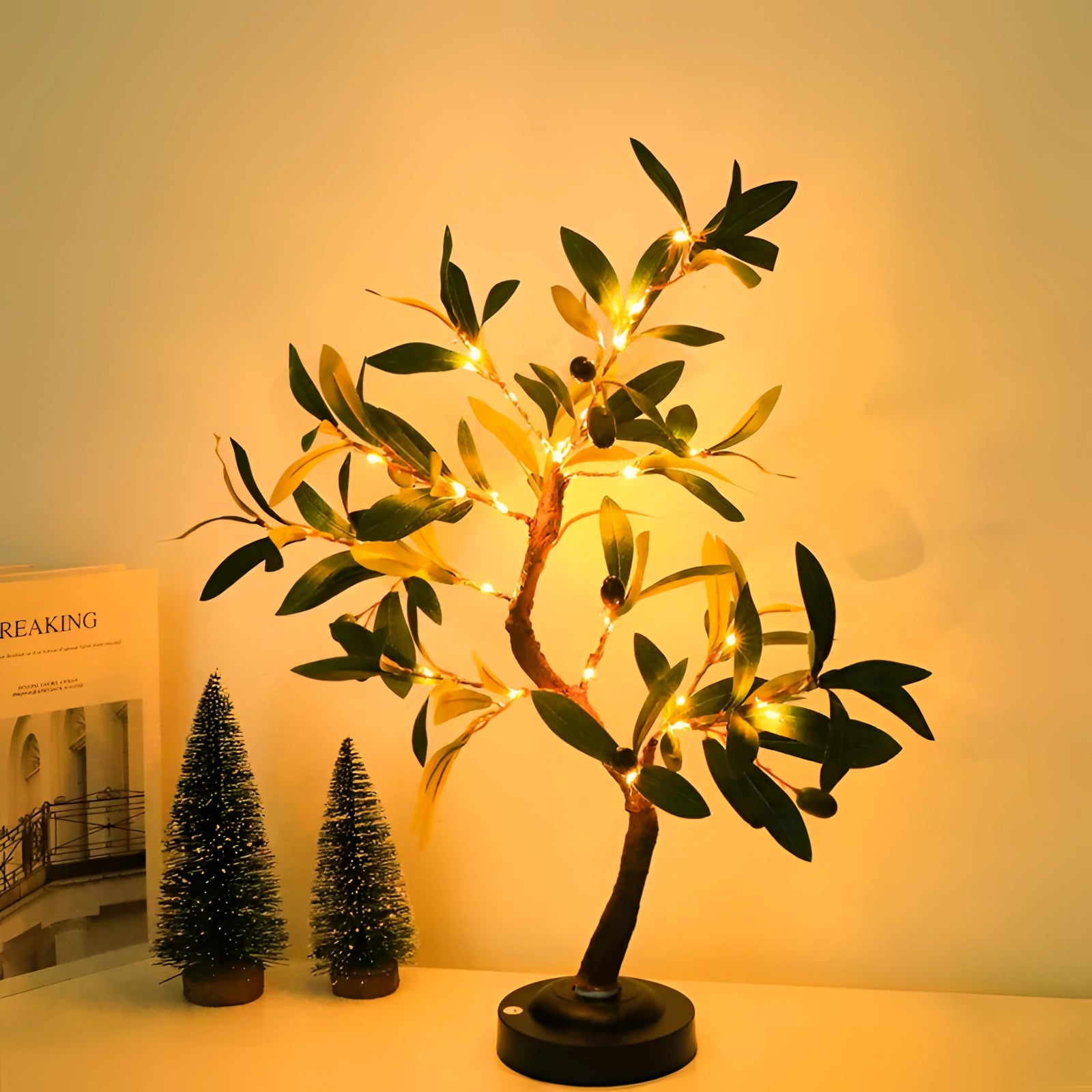 Artificial olive tree lamp with LED lights, featuring a realistic design with green leaves and branches in a decorative flowerpot, ideal for indoor decor.