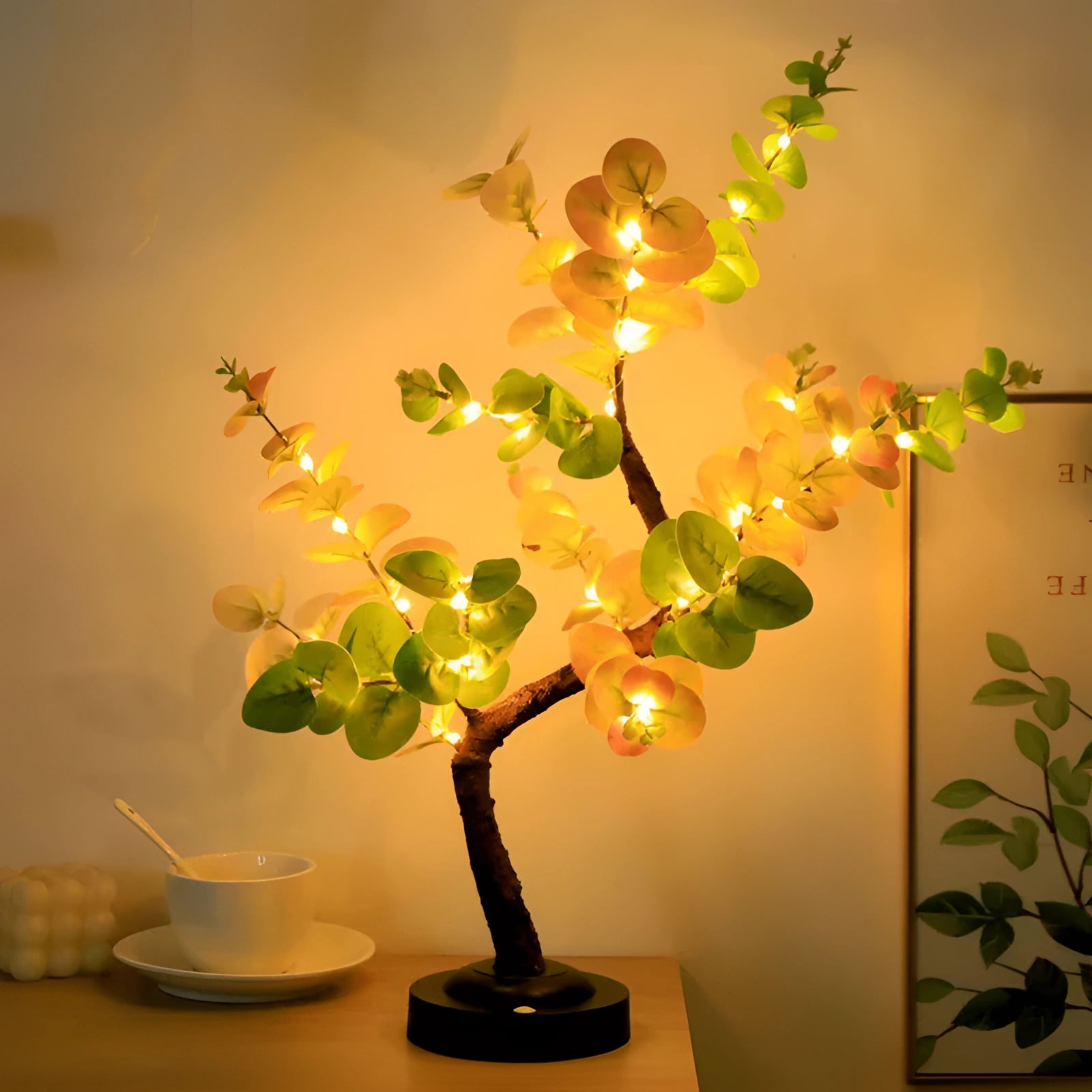 Indoor decorative olive tree lamp featuring LED lights with yellow leaf accents, housed in a stylish flowerpot, suitable for enhancing interior design with a warm, amber glow.
