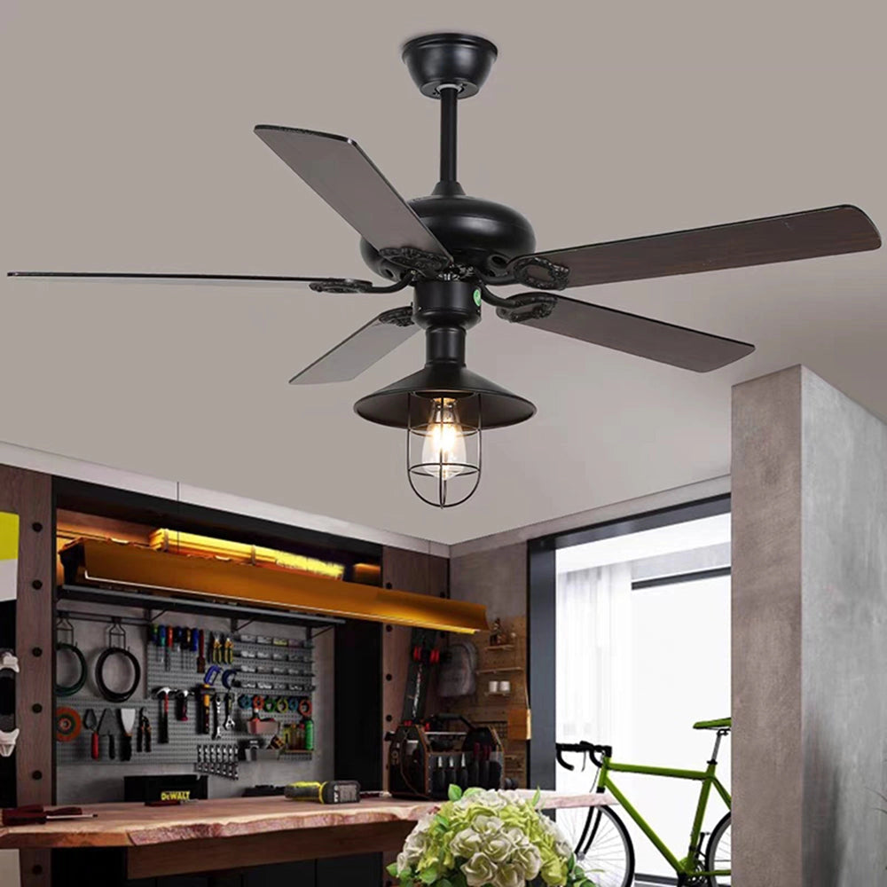 Industrial black ceiling fan with light and remote, featuring a vintage outdoor design, mounted on a wood ceiling in a modern interior space.