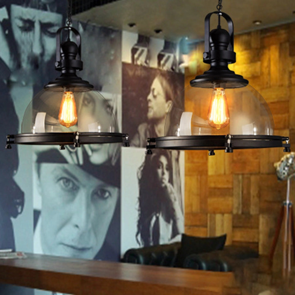 Industrial black iron pendant light with frosted glass dome, featuring a retro adjustable design.