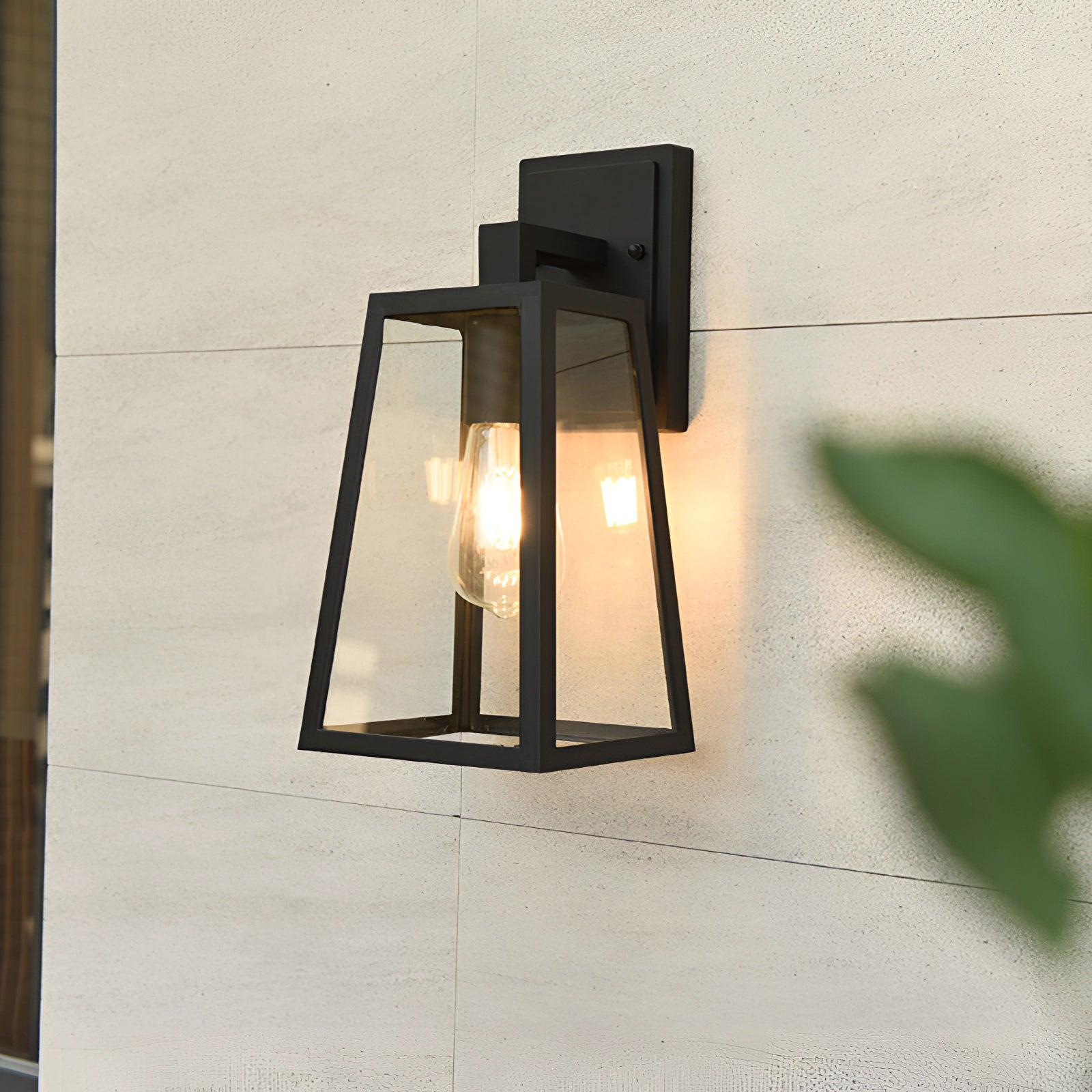 Industrial black trapezoidal wall sconce with a modern twin bulb fixture, featuring a sleek rectangular design with glass panels, mounted against a wooden backdrop.