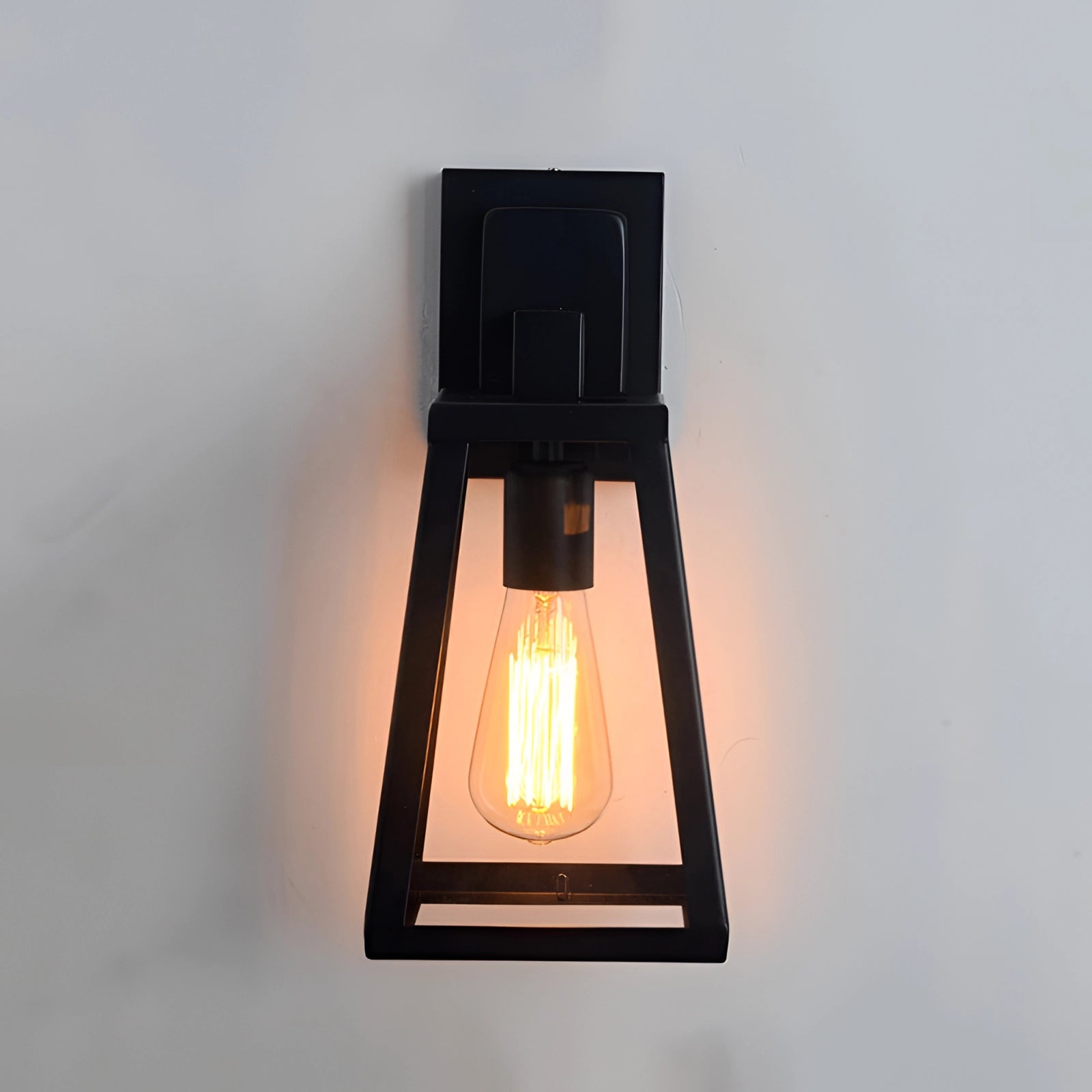 Industrial black trapezoidal wall sconce with a modern twin bulb fixture design.