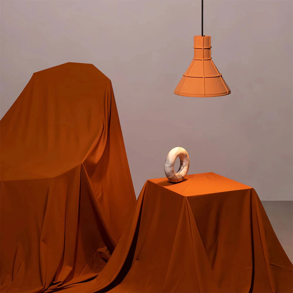 Orange and gray industrial concrete pendant light fixture with a minimalist design, featuring a wooden accent.