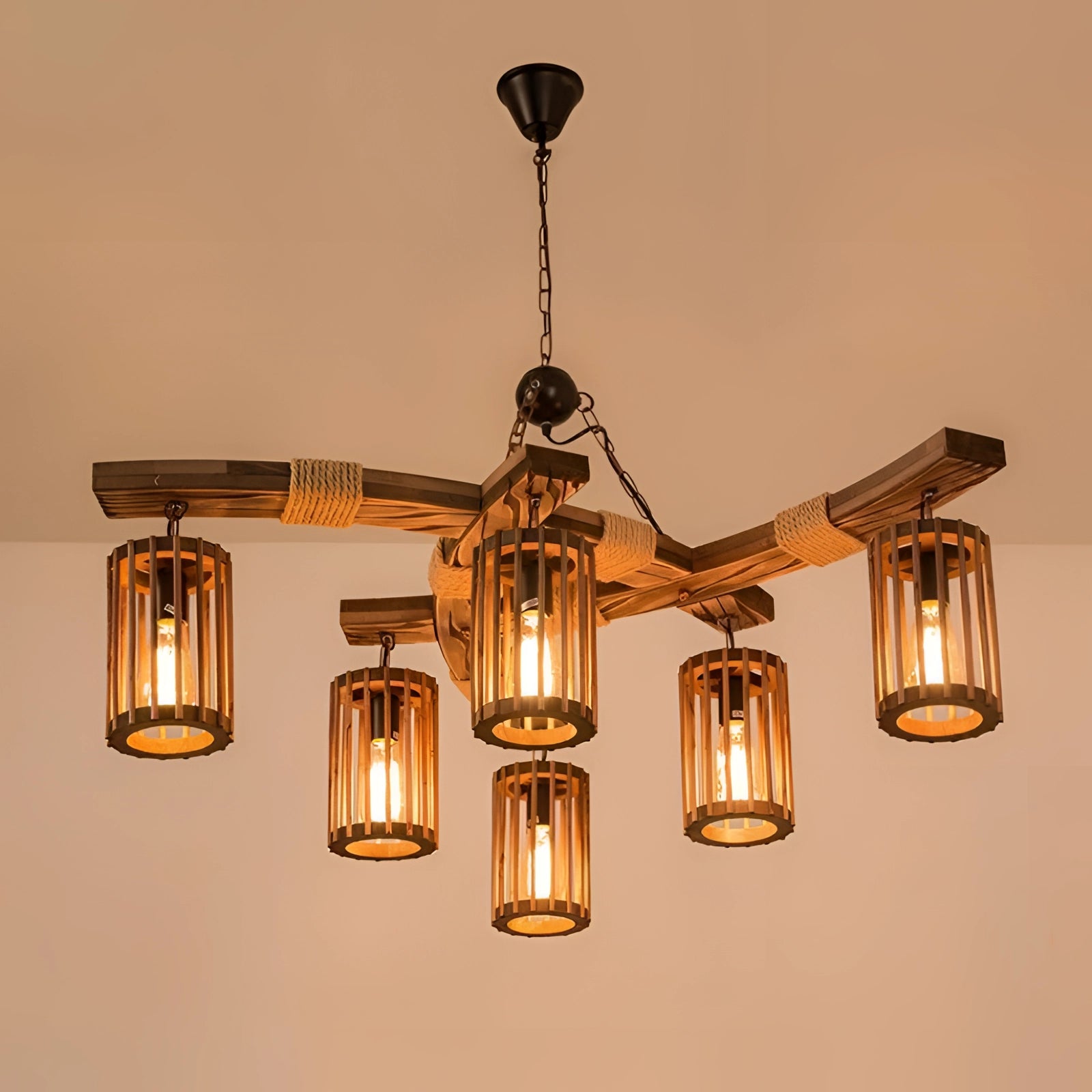 Industrial vintage cage pendant light with rustic wood beam and amber-tinted bulbs, featuring a metal rectangular chandelier design as a ceiling fixture.