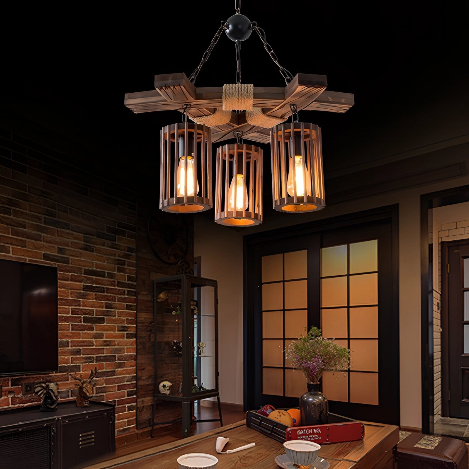 Three-light industrial vintage cage pendant light featuring a rustic wood beam chandelier design, hanging in an interior setting with elements of wood and other decor, enhancing the ambiance with its warm illumination.