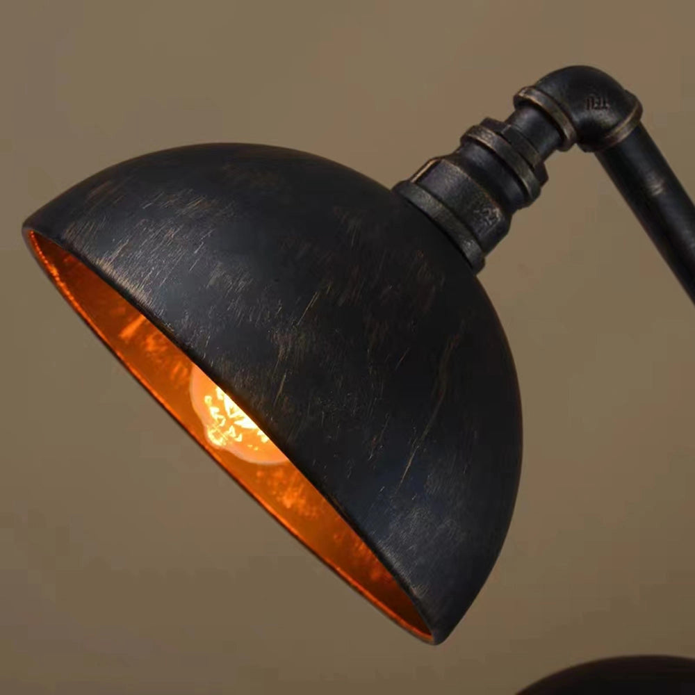 Industrial vintage-style dual dome pendant light made of black metal with pipe design, highlighting its rustic and modern aesthetic.