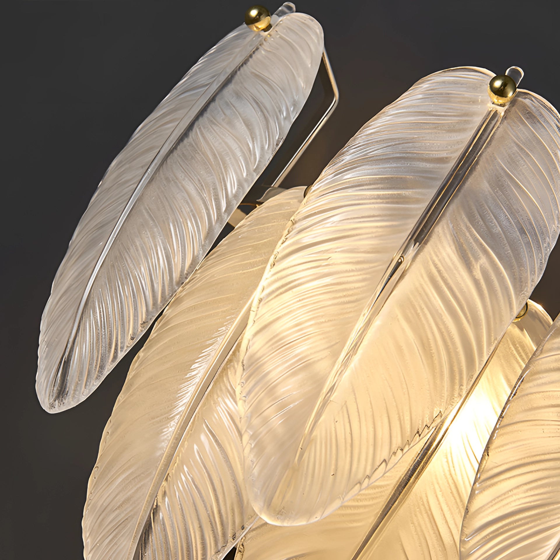 Leaf-shaped gold chandelier with intricate feather-like details, hanging in an elegant modern luxury bedroom setting.