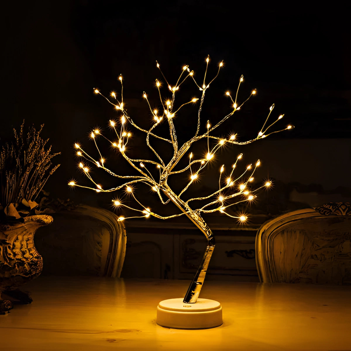 LED bonsai tree light with warm white LEDs arranged on delicate branches, resembling a miniature tree, housed in a sleek flowerpot. USB powered tabletop lamp designed for decorative indoor use.