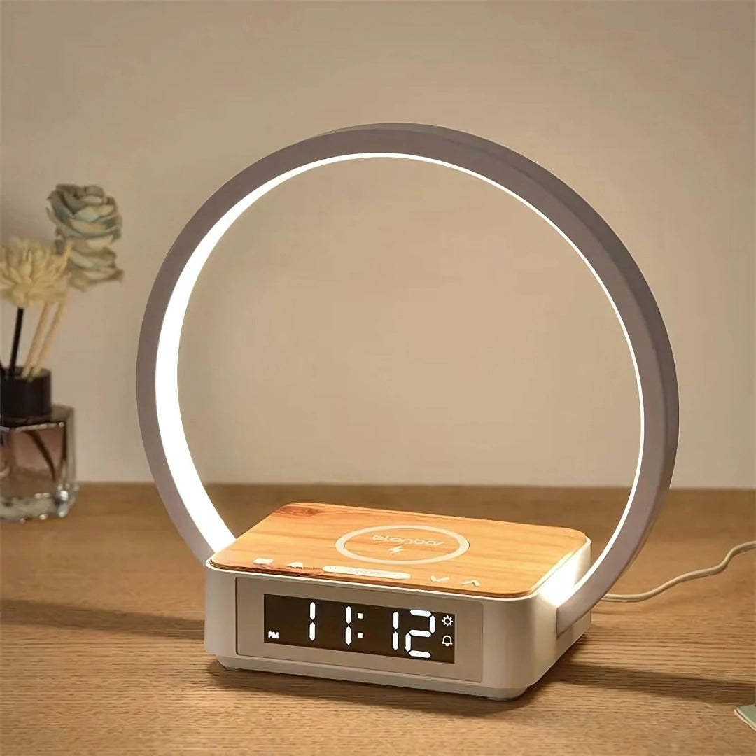 
A modern LED circle lamp with a digital time display, featuring a sleek design and USB-powered functionality. The lamp is shown on a wooden surface, highlighting its stylish and contemporary look suitable for a desk or bedside table.