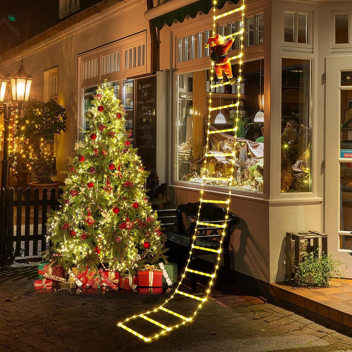 LED Climbing Santa figure decorated with festive garland, displayed on a Christmas tree, surrounded by holiday ornaments and warm lighting, creating a cozy holiday atmosphere in an interior setting.