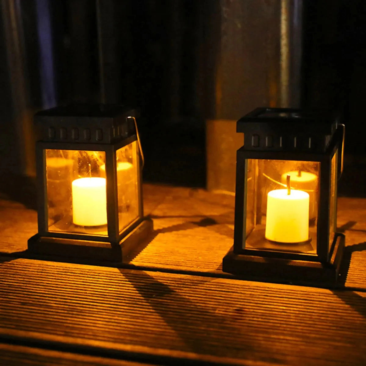 Black metal LED decorative outdoor lantern with a realistic flameless candle emitting a warm amber glow, suitable for weatherproof outdoor lighting.