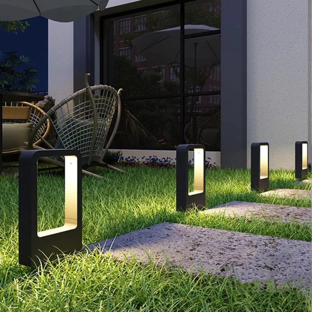 LED garden pathway lights illuminating a grassy outdoor pathway with plants and groundcover, showcasing their energy-efficient and weather-resistant design suitable for urban gardens.